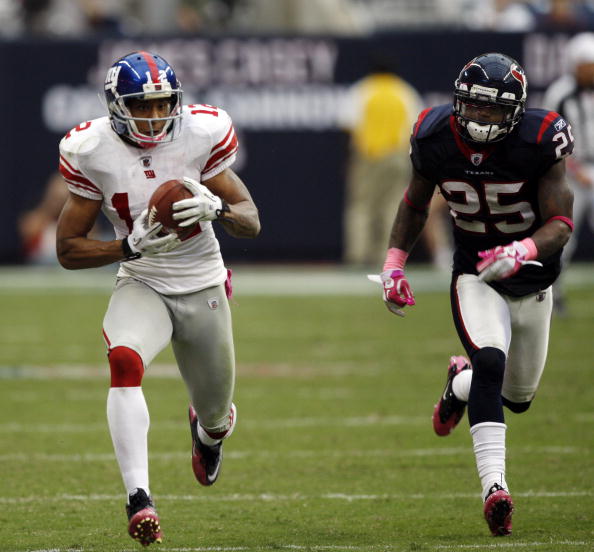 HOUSTON - OCTOBER 10:  Wide receiver Steve Smith #12 of the New York Giants  races down the sidelines as cornerback Kareem Jackson #25 pursues at Reliant Stadium on October 10, 2010 in Houston, Texas.  (Photo by Bob Levey/Getty Images)