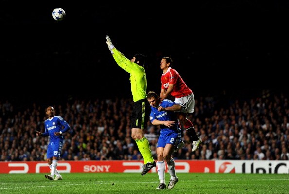 LONDON, ENGLAND - APRIL 06:  Goalkeeper Petr Cech of Chelsea claims the high ball as Javier Hernandez of Manchester United climbs up the back of Branislav Ivanovic of Chelsea during the UEFA Champions League quarter final first leg match between Chelsea a