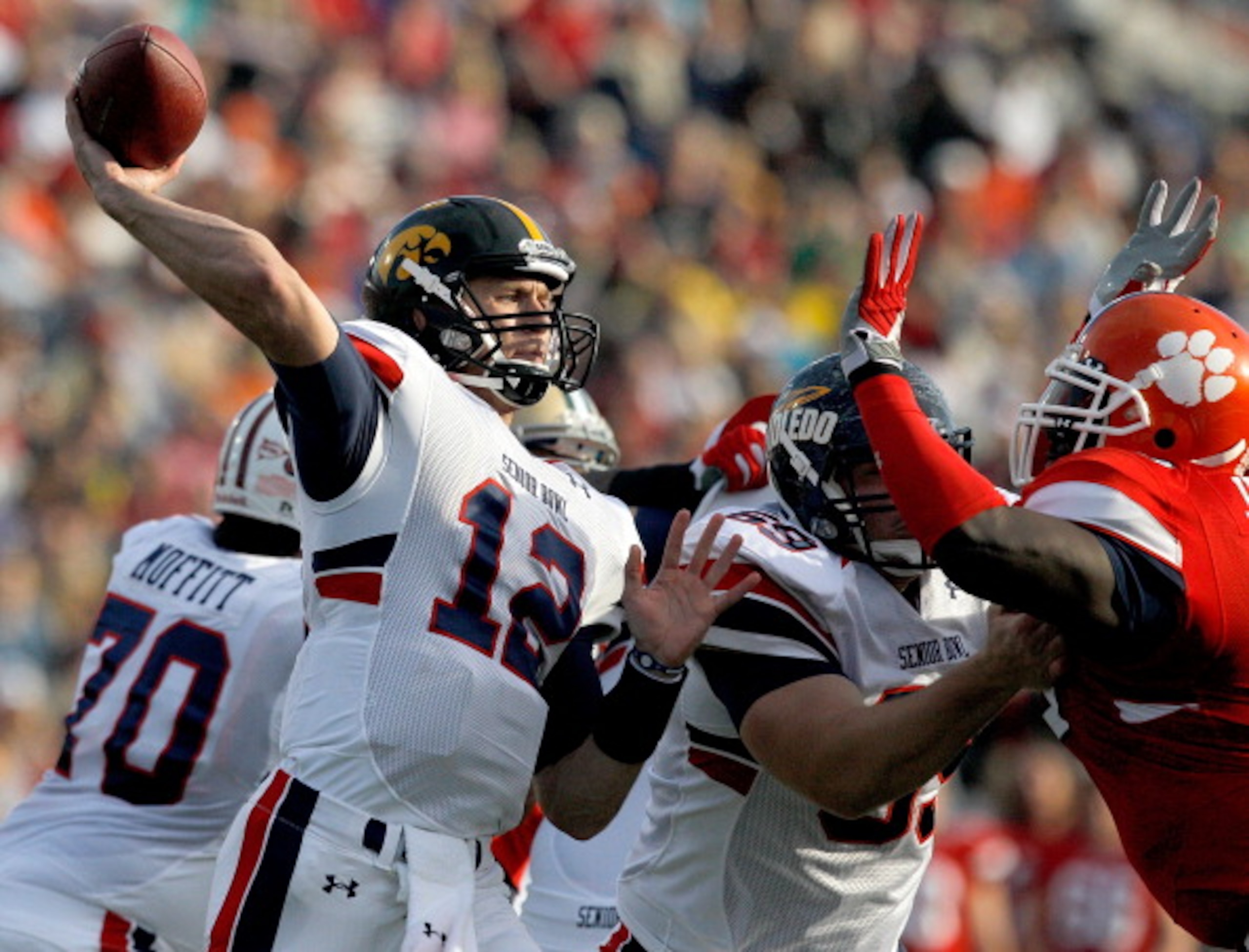 MOBILE, AL - JANUARY 29: Quarterback Ricky Stanzi #12 of the North Team passes over South Team defenders during second quarter of the Under Armour Senior Bowl on January 29, 2011 at Ladd Peebles Stadium in Mobile, Alabama. (Photo by Sean Gardner/Getty Im MOBILE, AL - JANUARY 29: Quarterback Ricky Stanzi #12 of the North Team passes over South Team defenders during second quarter of the Under Armour Senior Bowl on January 29, 2011 at Ladd Peebles Stadium in Mobile, Alabama. (Photo by Sean Gardner/Getty Im