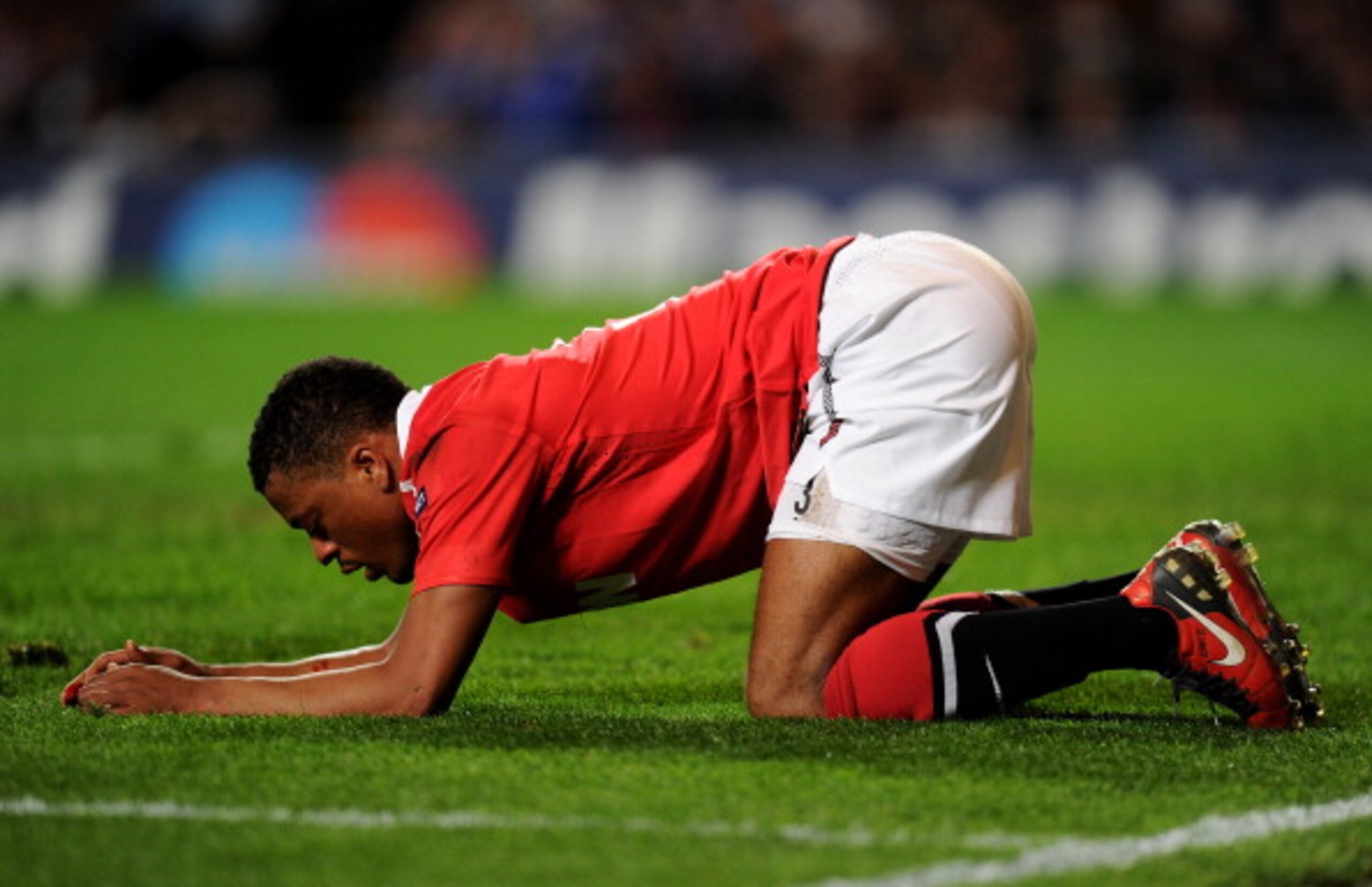 LONDON, ENGLAND - APRIL 06:  The injured Patrice Evra of Manchester United kneels on the pitch during the UEFA Champions League quarter final first leg match between Chelsea and Manchester United at Stamford Bridge on April 6, 2011 in London, England.  (P
