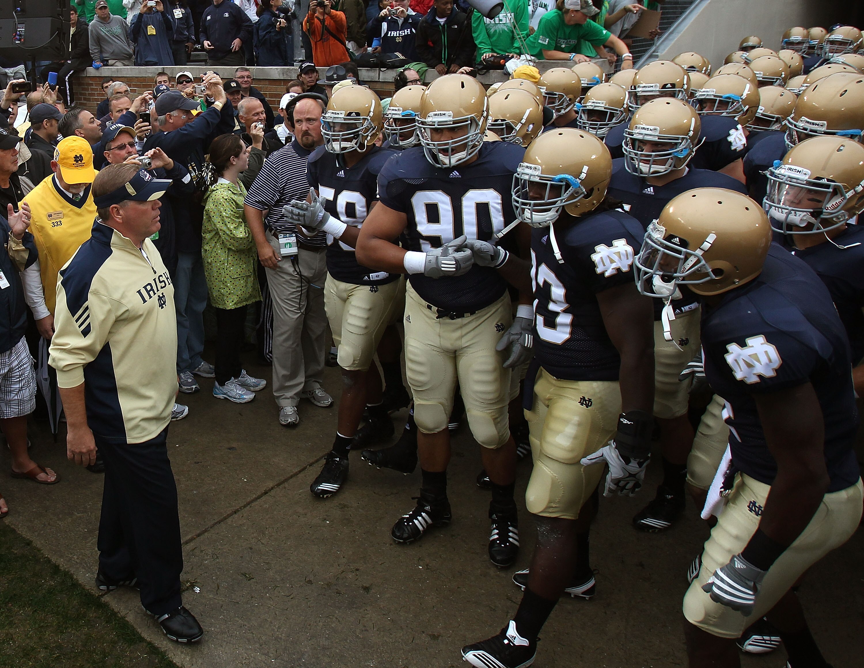 SOUTH BEND, IN - SEPTEMBER 11: Head coach Brian Kelly of the Notre Dame Fighting Irish (L) waits to enter the field with his team before a game against the Michigan Wolverines at Notre Dame Stadium on September 11, 2010 in South Bend, Indiana. Michigan de