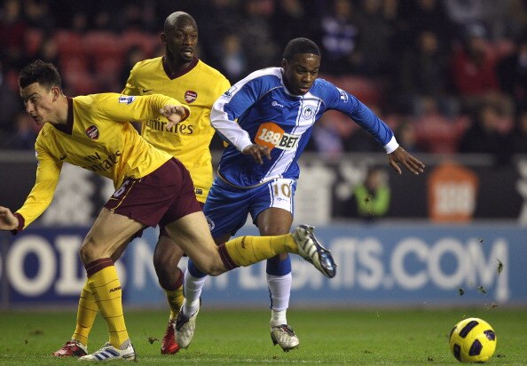 WIGAN, ENGLAND - DECEMBER 29:  Charles N'Zogbia (R) of Wigan Athletic is brought down by Laurent Koscielny of Arsenal to concede a penalty during the Barclays Premier League match between Wigan Athletic and Arsenal at DW Stadium on December 29, 2010 in Wi