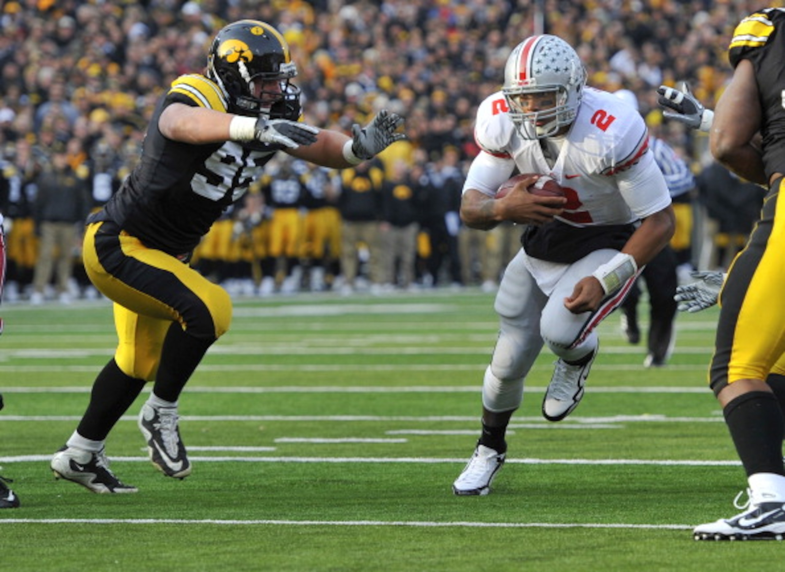 IOWA CITY, IA - NOVEMBER 20:  Defeisive lineman Karl Klug #95 of the University of Iowa Hawkeyes close in for the tackle on quarterback Terrelle Pryor #2 of the Ohio State Buckeyes as he drive the ball towards the goal line during the first half of play a