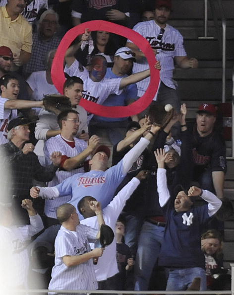 MINNEAPOLIS, MN - OCTOBER 7: Fans reach for a solo home run ball hit by Orlando Hudson #1 of the Minnesota Twins in the sixth inning during game two of the ALDS game against the New York Yankee on October 7, 2010 at Target Field in Minneapolis, Minnesota.