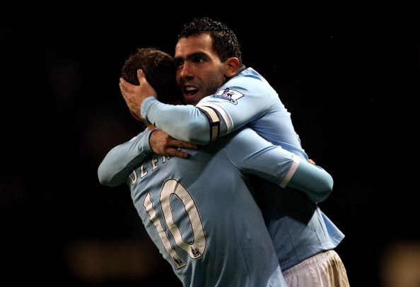 MANCHESTER, ENGLAND - JANUARY 15:  Carlos Tevez of Manchester City celebrates scoring his team's fourth goal with team mate Edin Dzeko during the Barclays Premier League match between Manchester City and Wolverhampton Wanderers at the City of Manchester S