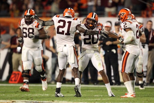 MIAMI, FL - JANUARY 03:  Rashad Carmichael #21 and Jayron Hosley #20 of the Virginai Tech Hokies celebrate after Hosley intercepted a pass in the second quarter against the Stanford Cardinal during the 2011 Discover Orange Bowl at Sun Life Stadium on Janu