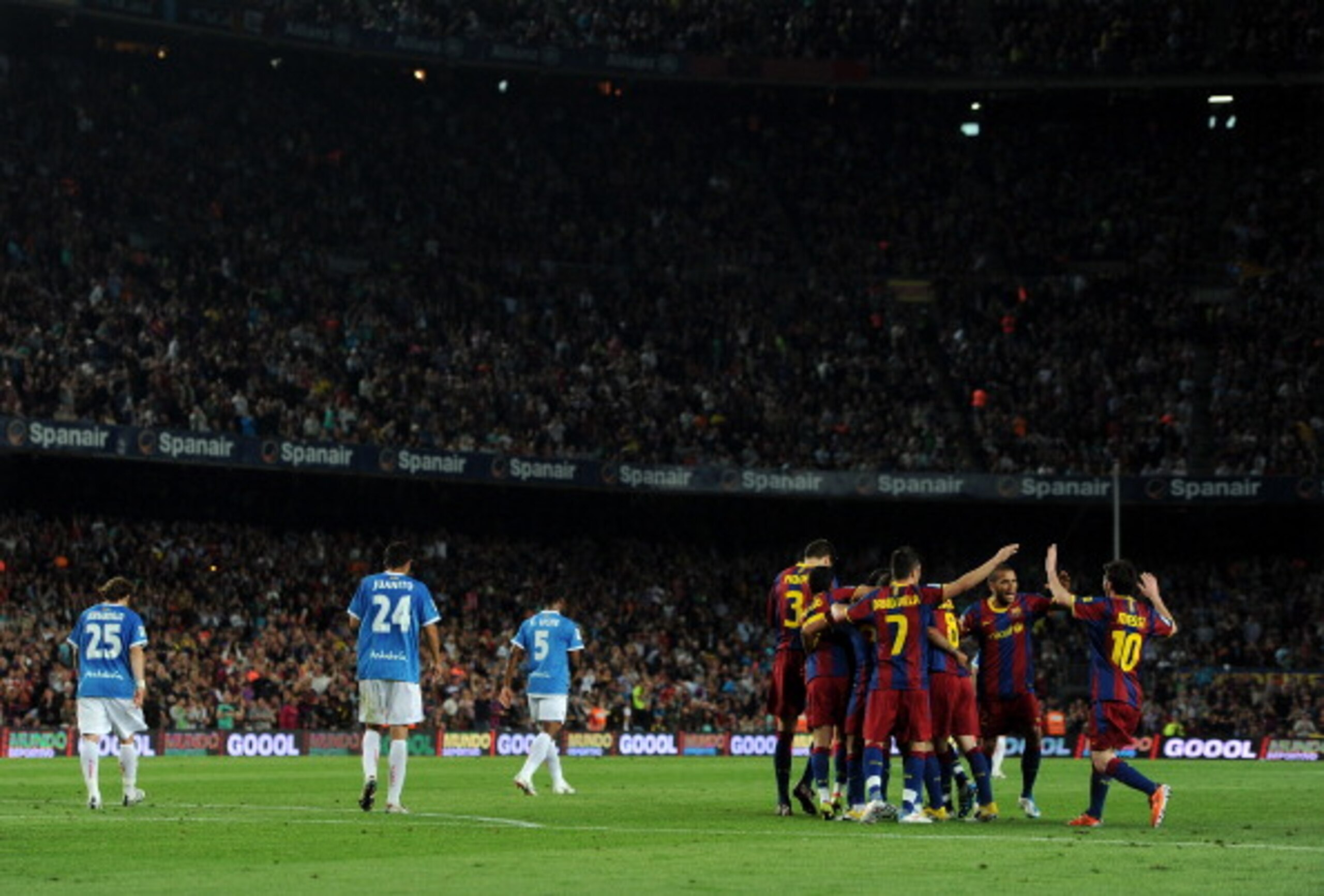 BARCELONA, SPAIN - APRIL 09: Lionel Messi (R) of Barcelona runs to join his teammates celebrating Thiago Alcantara his goal as Almeria players trudge back to the halfway line during the la Liga match between FC Barcelona and UD Almeria at the Camp Nou st BARCELONA, SPAIN - APRIL 09: Lionel Messi (R) of Barcelona runs to join his teammates celebrating Thiago Alcantara his goal as Almeria players trudge back to the halfway line during the la Liga match between FC Barcelona and UD Almeria at the Camp Nou st