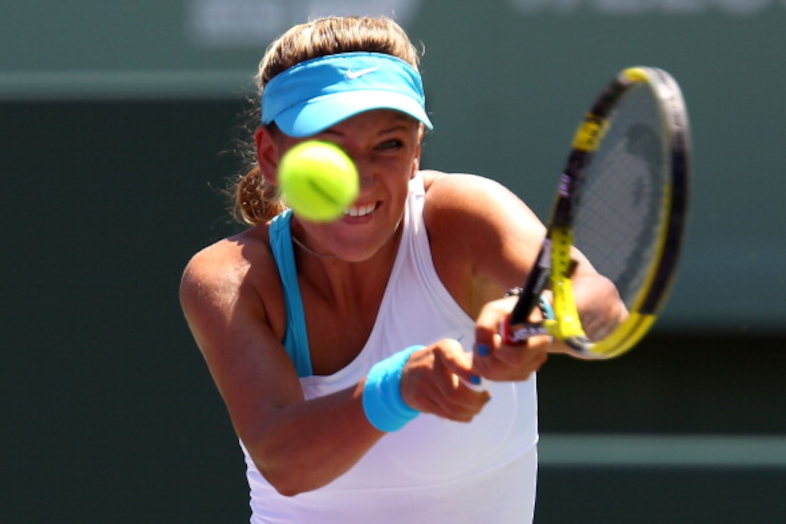 KEY BISCAYNE, FL - APRIL 02:  Victoria Azarenka of Belarus hits a backhand return against Maria Sharapova of Russia during the women's singles championship at the Sony Ericsson Open at Crandon Park Tennis Center on April 2, 2011 in Key Biscayne, Florida.