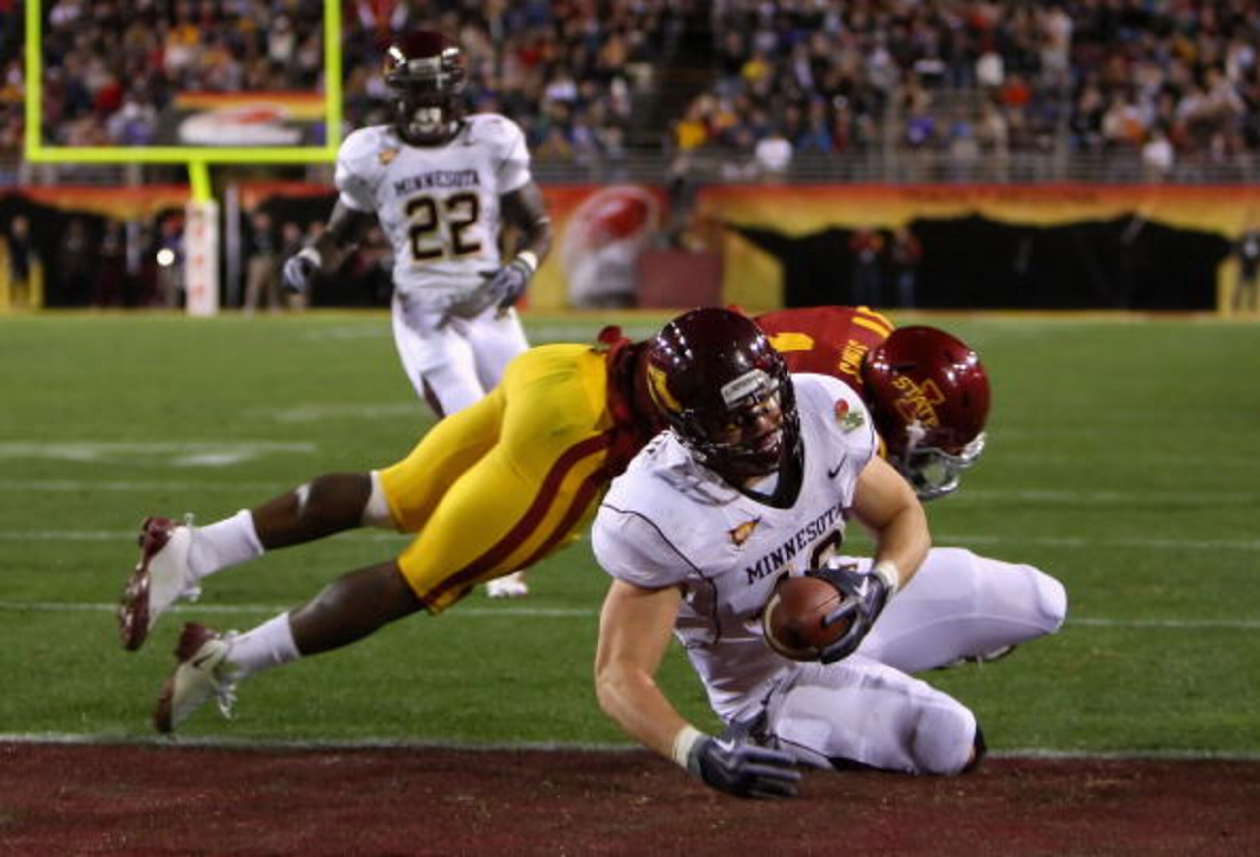 TEMPE, AZ - DECEMBER 31:  Tight end Nick Tow-Arnett #48 of the Minnesota Golden Gophers dives into the endzone to score on a 23 yard reception past David Sims #1 of the Iowa State Cyclones during the Insight Bowl at Arizona Stadium on December 31, 2009 in