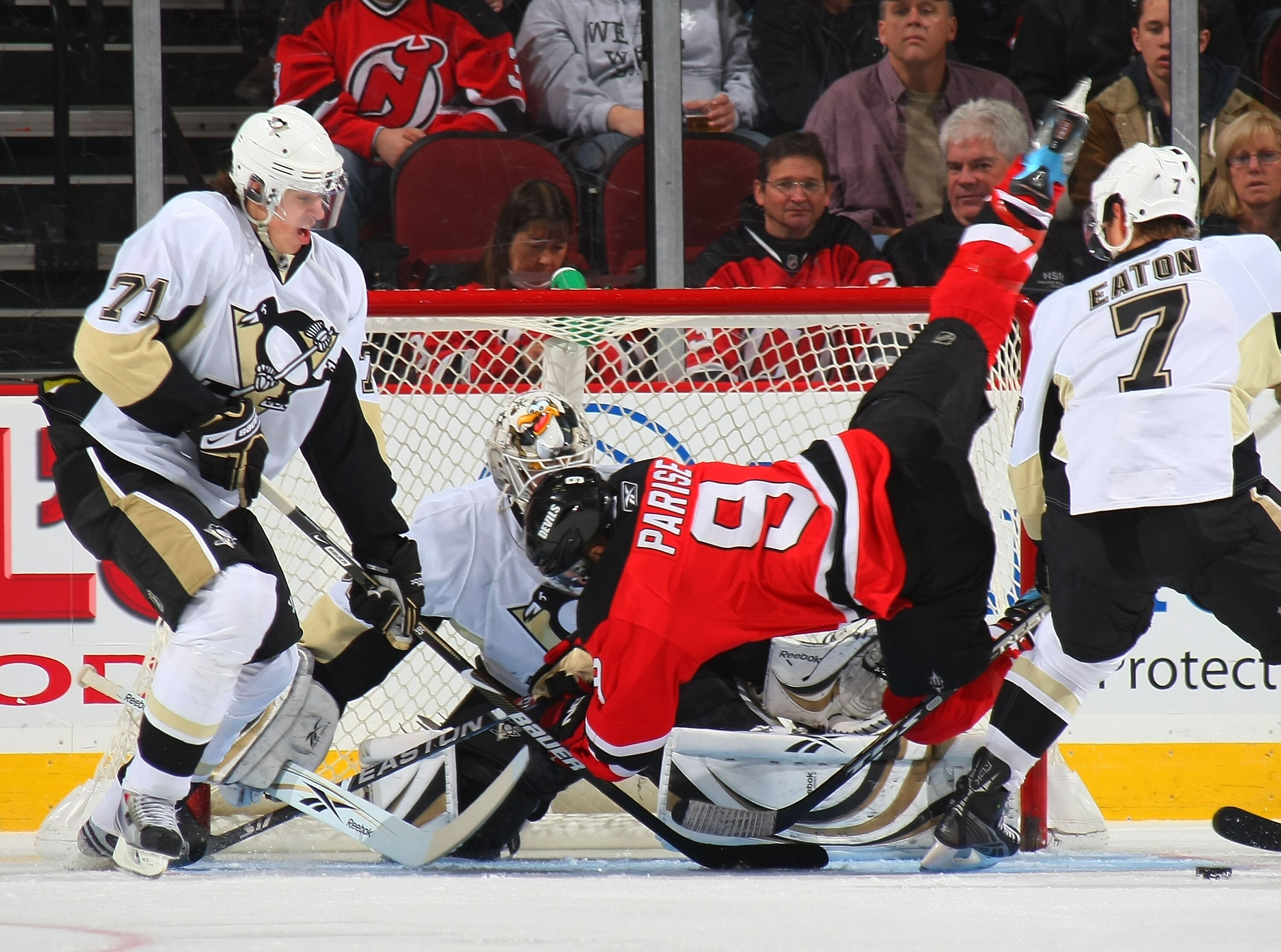 NEWARK, NJ - DECEMBER 10: Goaltender Dany Sabourin #30 of the Pittsburgh Penguins blocks a shot by Zach Parise #9 of the New Jersey Devils as Evgeni Malkin #71 looks for the rebound on December 10, 2008 at the Prudential Center in Newark, New Jersey. (Pho