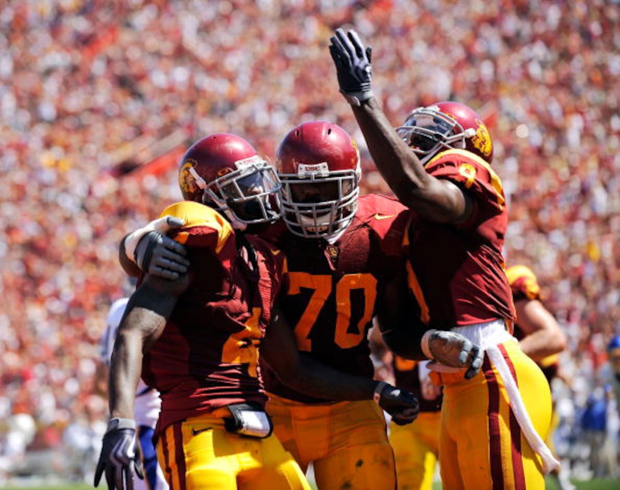 LOS ANGELES, CA - SEPTEMBER 05: Joe McKnight #4 of the USC Trojans celebrates his touchdown with Tyron Smith #70 and David Ausberry #9 during the second quarter against the San Jose State Spartans at Los Angeles Memorial Coliseum on September 5, 2009 in LOS ANGELES, CA - SEPTEMBER 05: Joe McKnight #4 of the USC Trojans celebrates his touchdown with Tyron Smith #70 and David Ausberry #9 during the second quarter against the San Jose State Spartans at Los Angeles Memorial Coliseum on September 5, 2009 in