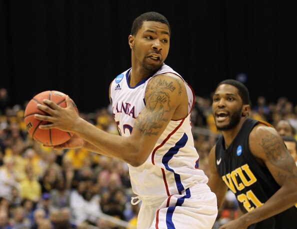 SAN ANTONIO, TX - MARCH 27:  Marcus Morris #22 of the Kansas Jayhawks handles the ball against Jamie Skeen #21 of the Virginia Commonwealth Rams during the southwest regional final of the 2011 NCAA men's basketball tournament at the Alamodome on March 27,
