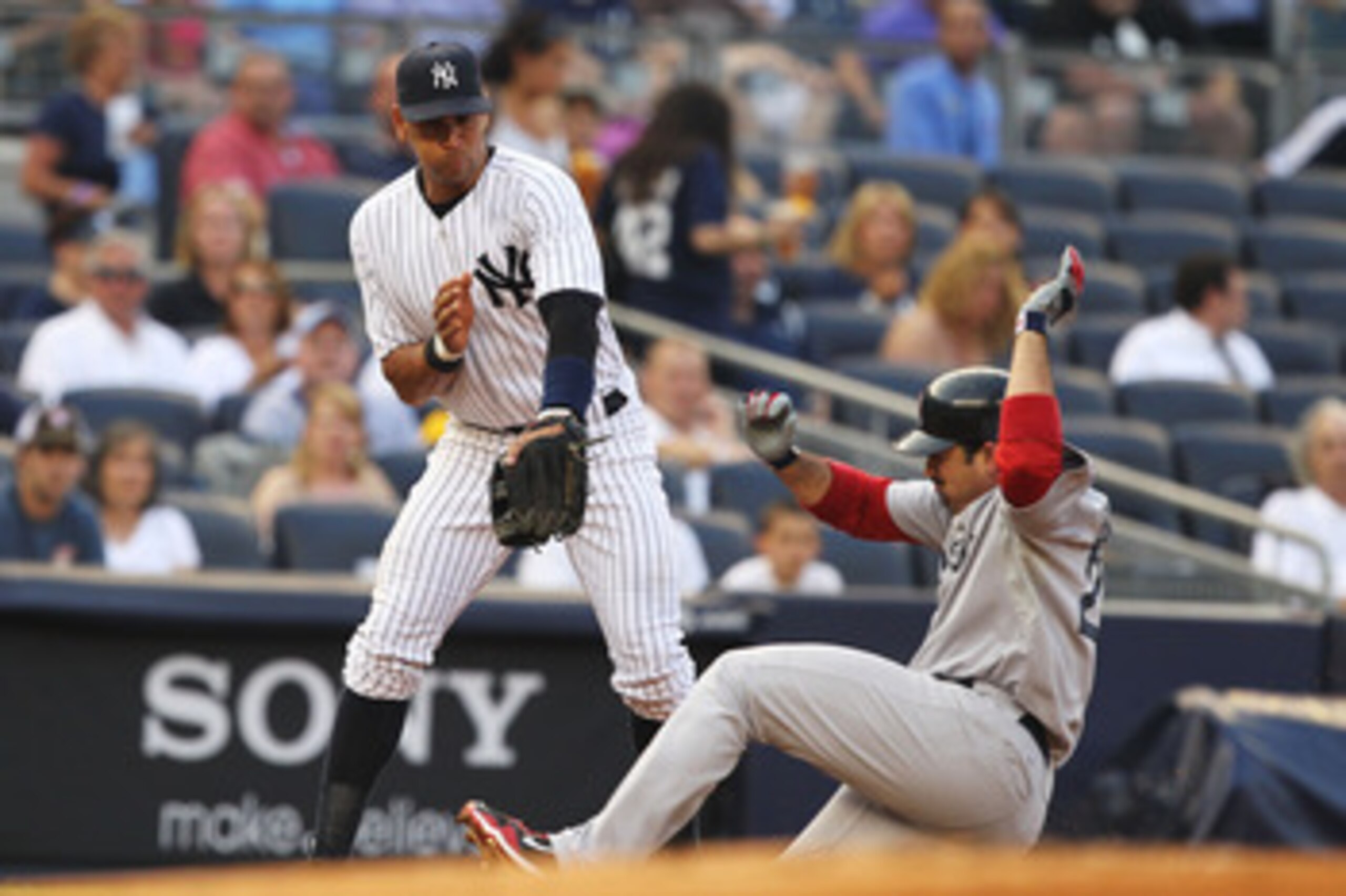 NEW YORK, NY - JUNE 07:  Alex Rodriguez #13 of the New York Yankees is late to recieve the throw as Adrian Gonzalez #28 of the Boston Red Sox slides into third base with a triple during their game on June 7, 2011 at Yankee Stadium in the Bronx borough of