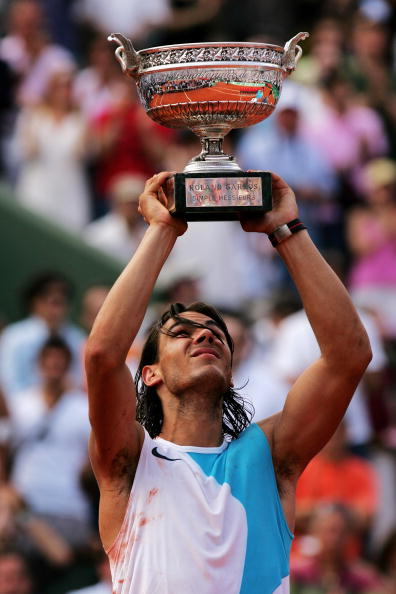 PARIS - JUNE 10:  Rafael Nadal of Spain holds the Philippe Chatrier Trophy aloft after winning against Roger Federer of Switzerland in the Men's Singles Final on day fifteen of the French Open at Roland Garros on June 10, 2007 in Paris, France.  (Photo by