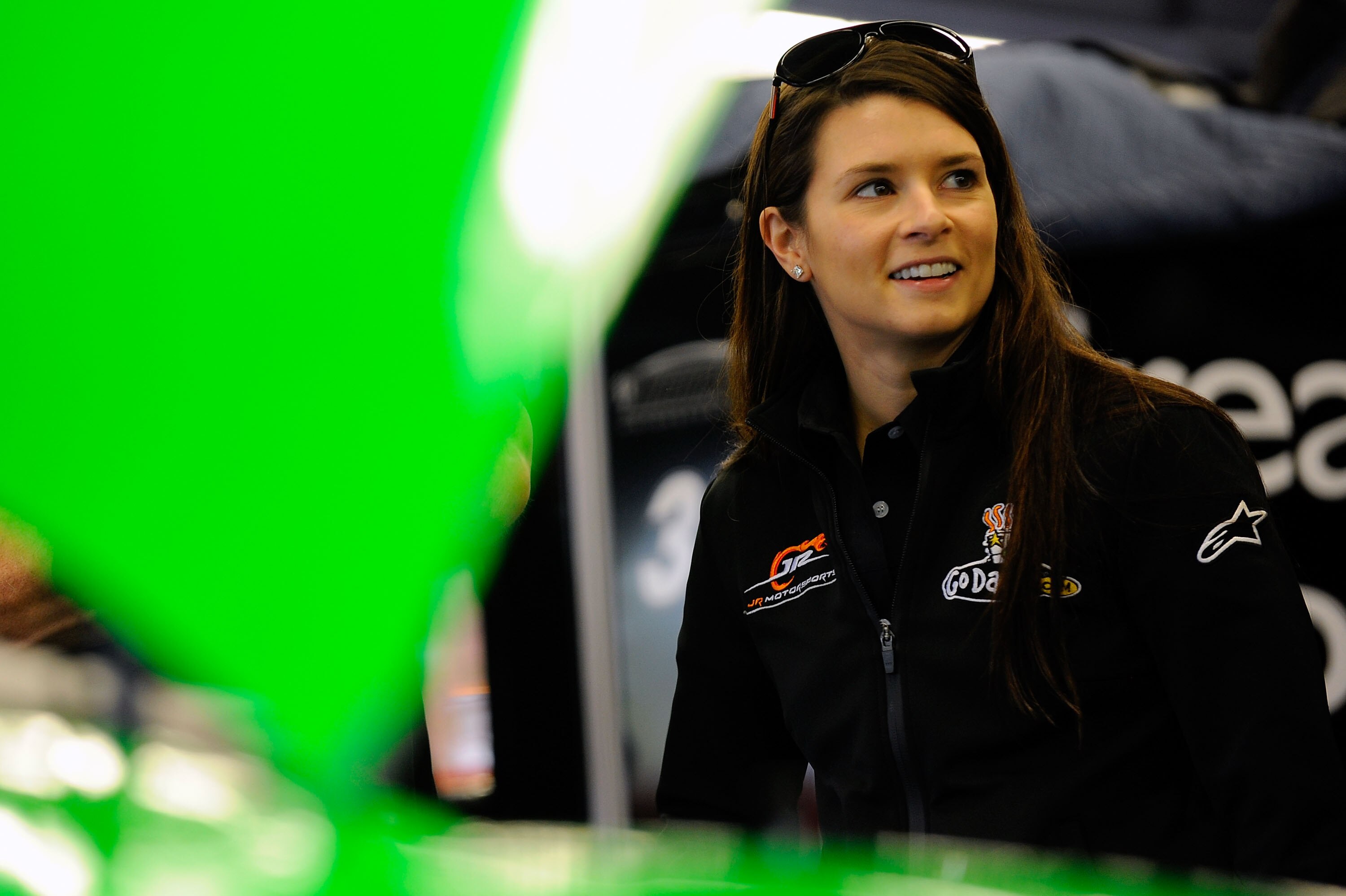 DAYTONA BEACH, FL - FEBRUARY 16:  Danica Patrick, driver of the #7 GoDaddy.com Chevrolet, stands in the garage prior to practice for the NASCAR Nationwide Series DRIVE4COPD 300 at Daytona International Speedway on February 16, 2011 in Daytona Beach, Flori