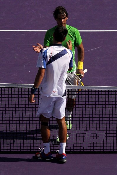 KEY BISCAYNE, FL - APRIL 03:  Novak Djokovic (bottom) of Serbia is congratulated by Rafael Nadal of Spain after Djokovic won their match during the men's singles championship at the Sony Ericsson Open at Crandon Park Tennis Center on April 3, 2011 in Key