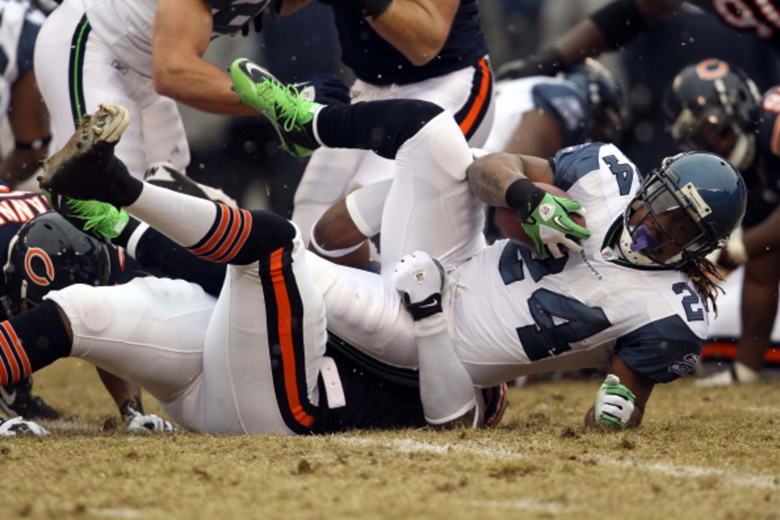 CHICAGO, IL - JANUARY 16: Running back Marshawn Lynch #24 of the Seattle Seahawks is tackled by Israel Idonije #71 of the Chicago Bears after a run in the first quarter during the 2011 NFC divisional playoff game at Soldier Field on January 16, 2011 in C CHICAGO, IL - JANUARY 16: Running back Marshawn Lynch #24 of the Seattle Seahawks is tackled by Israel Idonije #71 of the Chicago Bears after a run in the first quarter during the 2011 NFC divisional playoff game at Soldier Field on January 16, 2011 in C