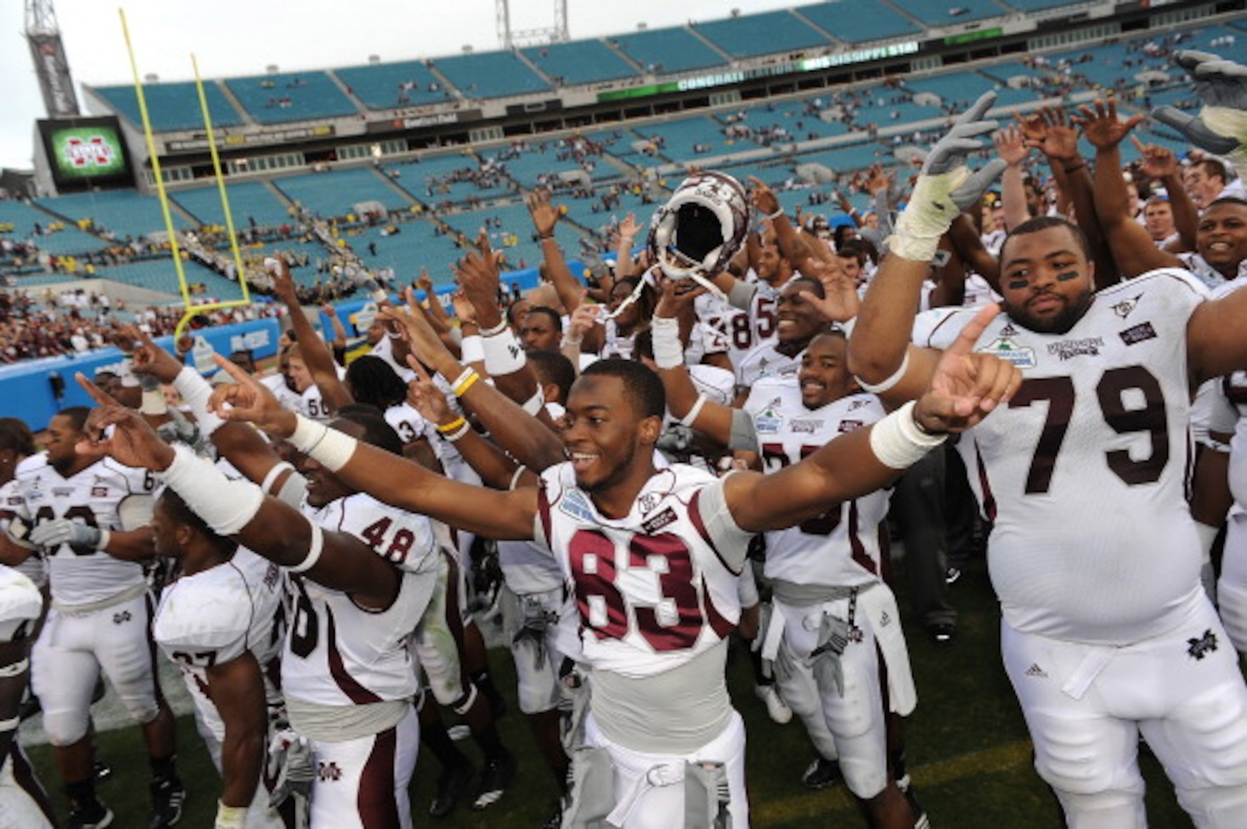JACKSONVILLE, FL - JANUARY 01:  The Mississippi Bulldogs players celebrate following their victory over the Michigan Wolverines at the Gator Bowl at EverBank Field on January 1, 2011 in Jacksonville, Florida  (Photo by Rick Dole/Getty Images)
