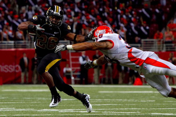 ST. LOUIS - SEPTEMBER 4: De'Vion Moore #26 of the University of Missouri Tigers looks to get past Ian Thomas #38 of the University of Illinois Fighting Illini during the State Farm Arch Rivalry game on September 4, 2010 at the Edward Jones Dome in St. Lou