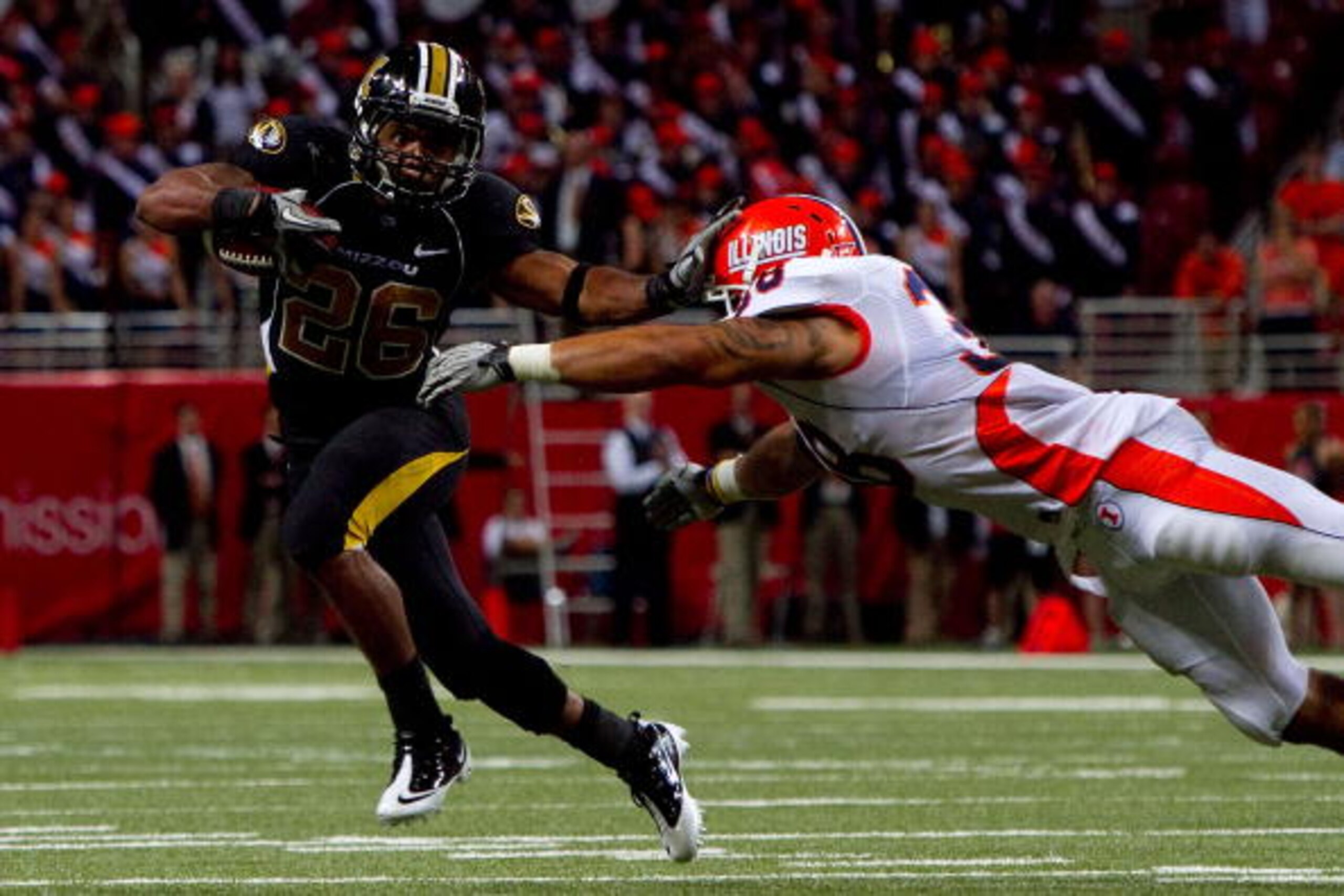 ST. LOUIS - SEPTEMBER 4: De'Vion Moore #26 of the University of Missouri Tigers looks to get past Ian Thomas #38 of the University of Illinois Fighting Illini during the State Farm Arch Rivalry game on September 4, 2010 at the Edward Jones Dome in St. Lou