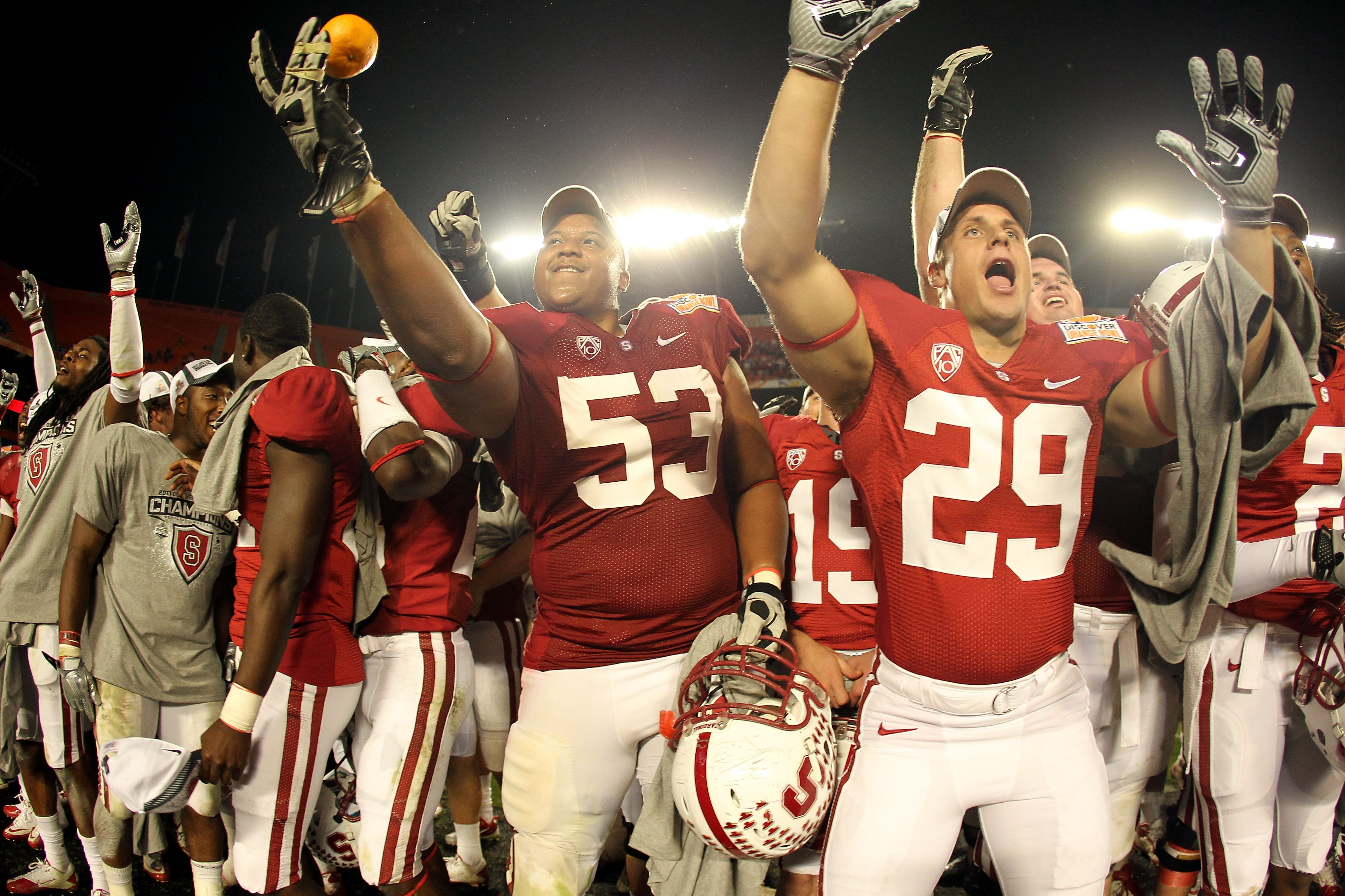 MIAMI, FL - JANUARY 03:  Derek Hall #53 and Ed Reynolds #29 of the Stanford Cardinal celebrates after Stanford won 40-12 against the Virginia Tech Hokies during the 2011 Discover Orange Bowl at Sun Life Stadium on January 3, 2011 in Miami, Florida.  (Phot