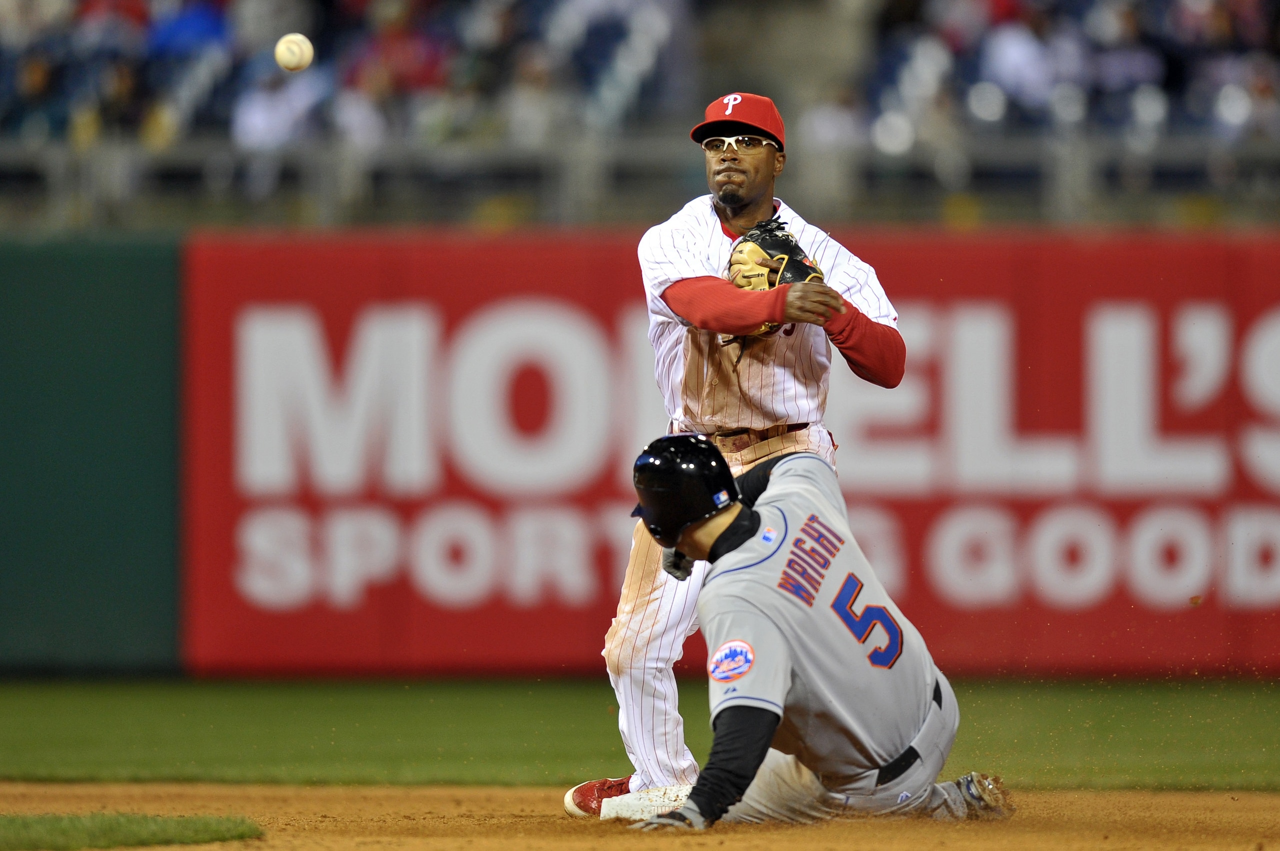 PHILADELPHIA, PA - APRIL 05: Jimmy Rollins #11 of the Philadelphia Phillies makes a throw to first for a double play after getting David Wright #5 of the New York Mets out at second base at Citizens Bank Park on April 5, 2011 in Philadelphia, Pennsylvania PHILADELPHIA, PA - APRIL 05: Jimmy Rollins #11 of the Philadelphia Phillies makes a throw to first for a double play after getting David Wright #5 of the New York Mets out at second base at Citizens Bank Park on April 5, 2011 in Philadelphia, Pennsylvania