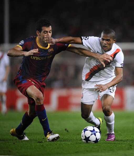 BARCELONA, SPAIN - APRIL 06:  Sergio Busquets of FC Barcelona (L) fights for the ball against Douglas Costa of Shakhtar Donetsk during the UEFA Champions League quarter final first leg match between Barcelona and Shakhtar Donetsk at the Camp Nou Stadium o
