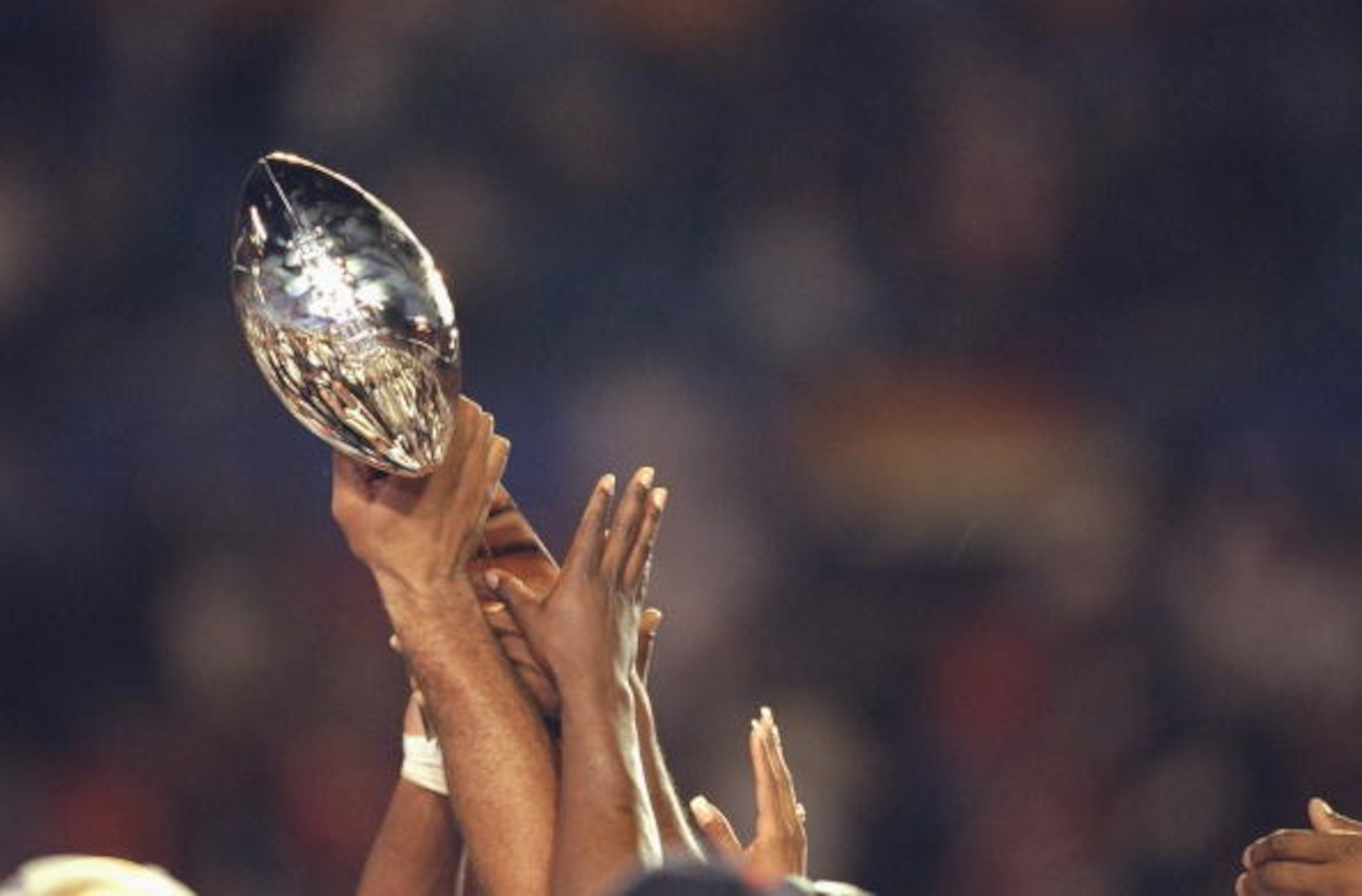 31 Jan 1999: The Denver Bronco players hold up the Lombardi Trophy after winning the Superbowl XXXIII against the Atlanta Falcons at the Pro Player Stadium in Miami, Florida. The Broncos defeated the Falcons 34-19. Mandatory Credit: Andy Lyons  /Allsport