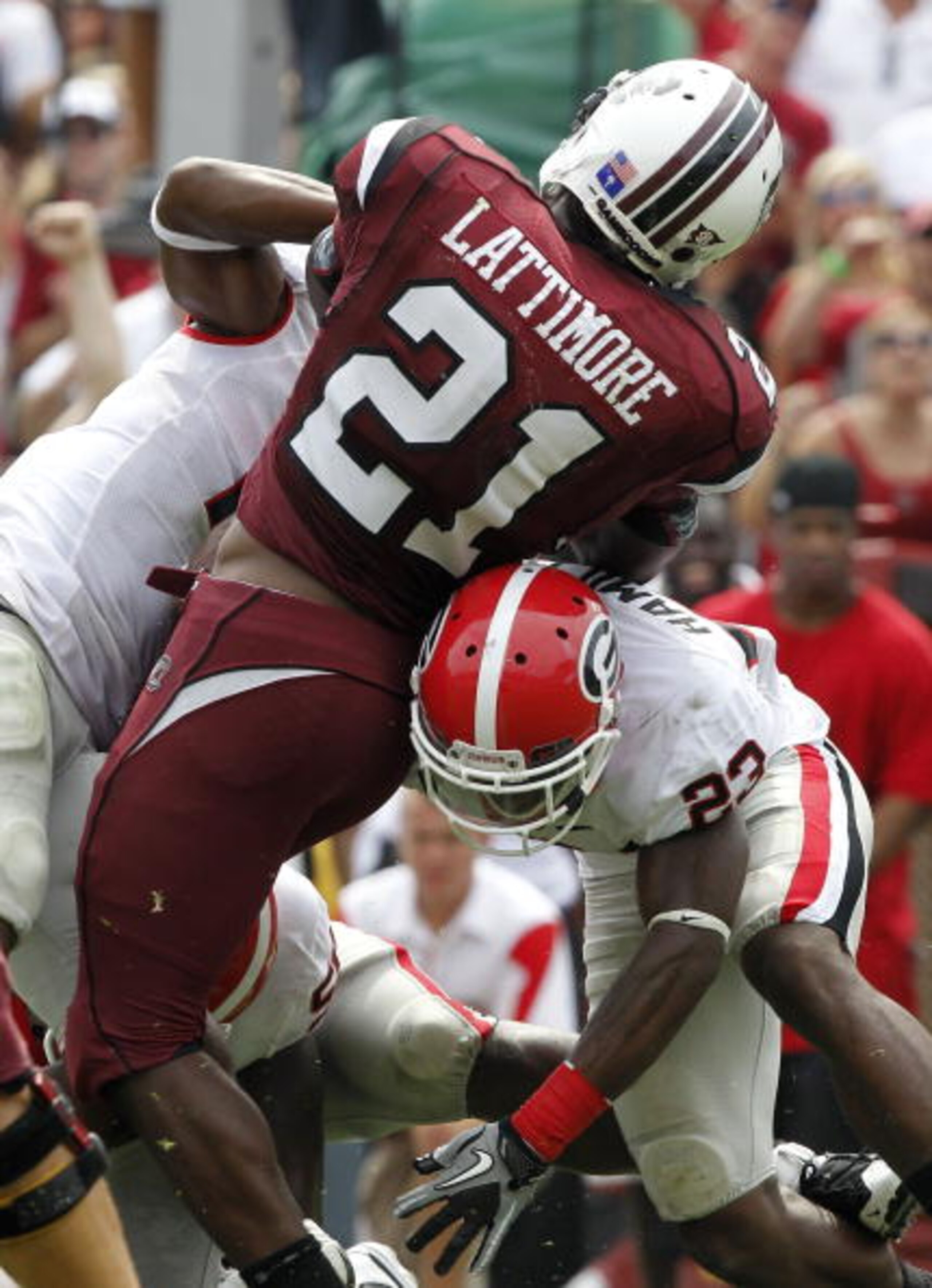 COLUMBIA, SC - SEPTEMBER 11: Tailback Marcus Lattimore #21 of the South Carolina Gamecocks is tackled by safety Jakar Hamilton #23 of the Georgia Bulldogs during the game at Williams-Brice Stadium on September 11, 2010 in Columbia, South Carolina. The Gam