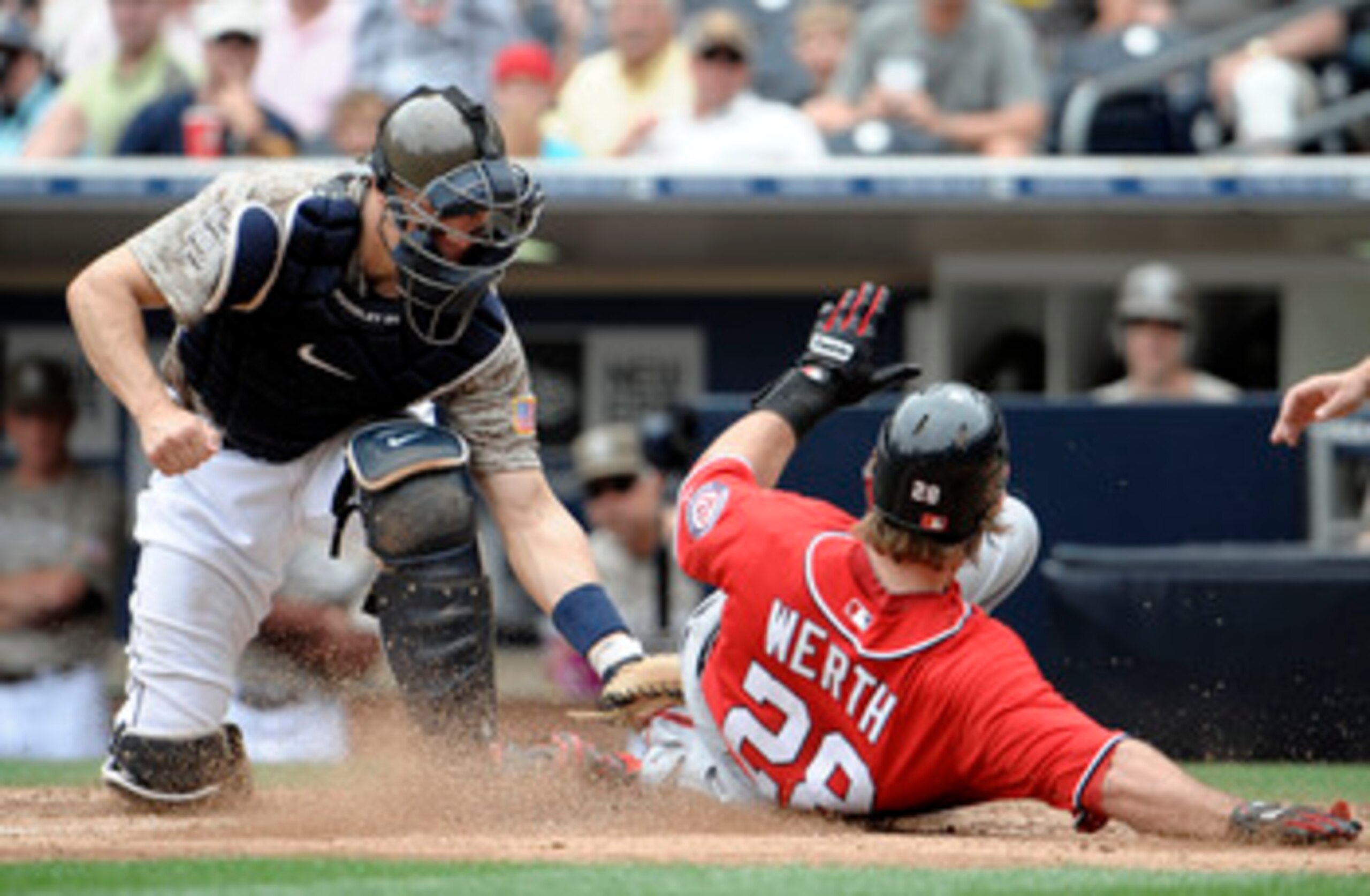 SAN DIEGO, CA - JUNE 12: Jayson Werth #28 of the Washington Nationals is tagged out at the plate by Nick Hundley #4 of the San Diego Padres during the ninth inning of a baseball game at Petco Park on June 12, 2011 in San Diego, California. The Nationals w