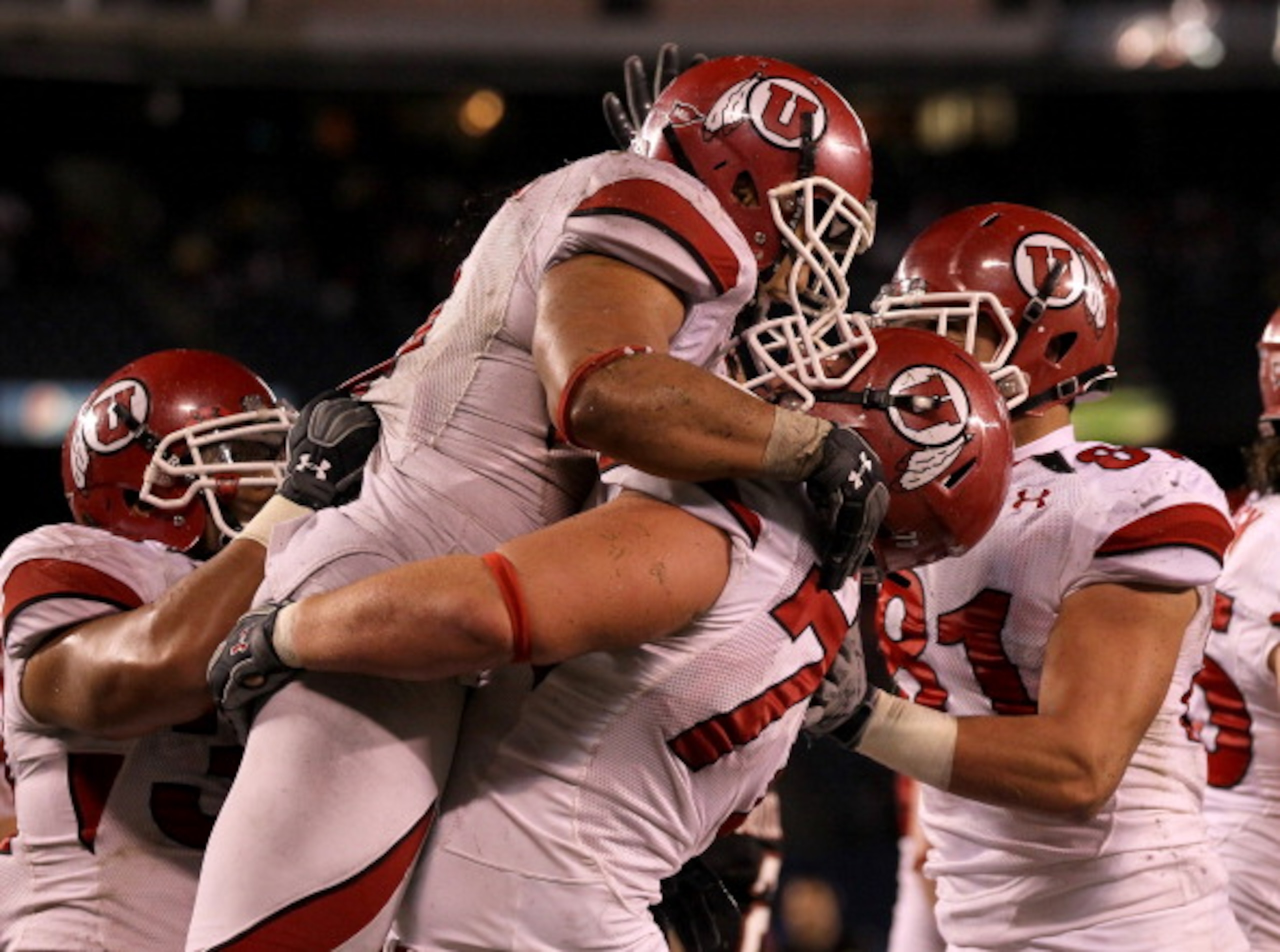 SAN DIEGO - NOVEMBER 20: Running back Matt Asiata #4 and center Zane Taylor #77 of the Utah Utes celebrate Asiata's one yard touchdown run against the San Diego State Aztecs in the fourth quarter at Qualcomm Stadium on November 20, 2010 in San Diego, Ca SAN DIEGO - NOVEMBER 20: Running back Matt Asiata #4 and center Zane Taylor #77 of the Utah Utes celebrate Asiata's one yard touchdown run against the San Diego State Aztecs in the fourth quarter at Qualcomm Stadium on November 20, 2010 in San Diego, Ca