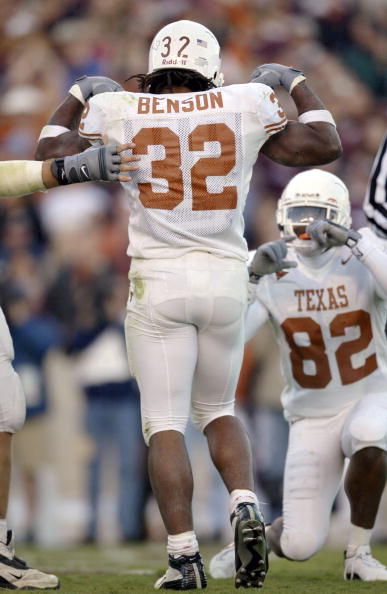 CORRECTED: COLLEGE STATION, TX - NOVEMBER 28:  Running back Cedric Benson #32 of the Texas Longhorns flexes his biceps and poses after a touchdown as B.J. Johnson #82 pretends to take his picture against the Texas A&M Aggies in the third quarter November