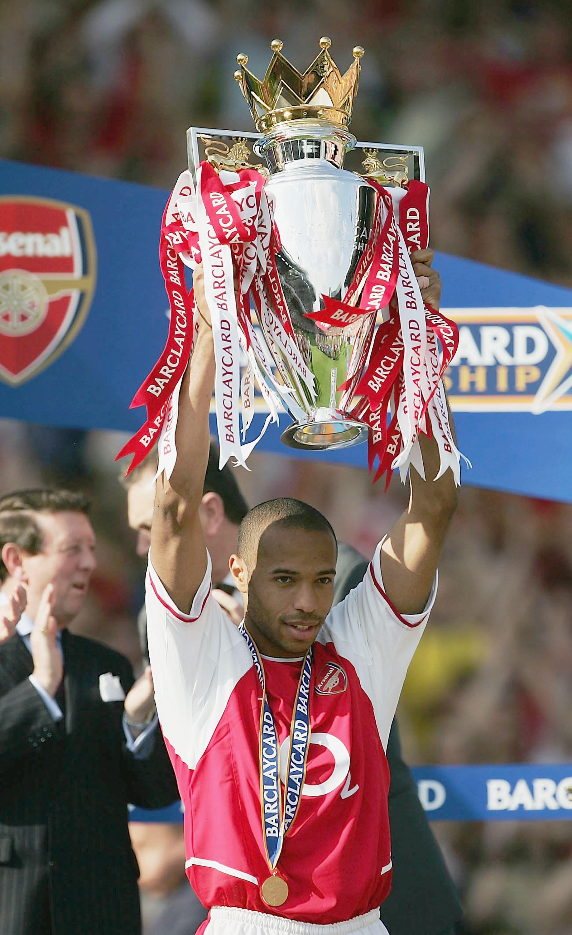 LONDON - MAY 15:  Thierry Henry of Arsenal lifts the Premiership trophy during the FA Barclaycard Premiership match between Arsenal and Leicester City at Highbury on May 15, 2004 in London.  (Photo by Clive Mason/Getty Images)