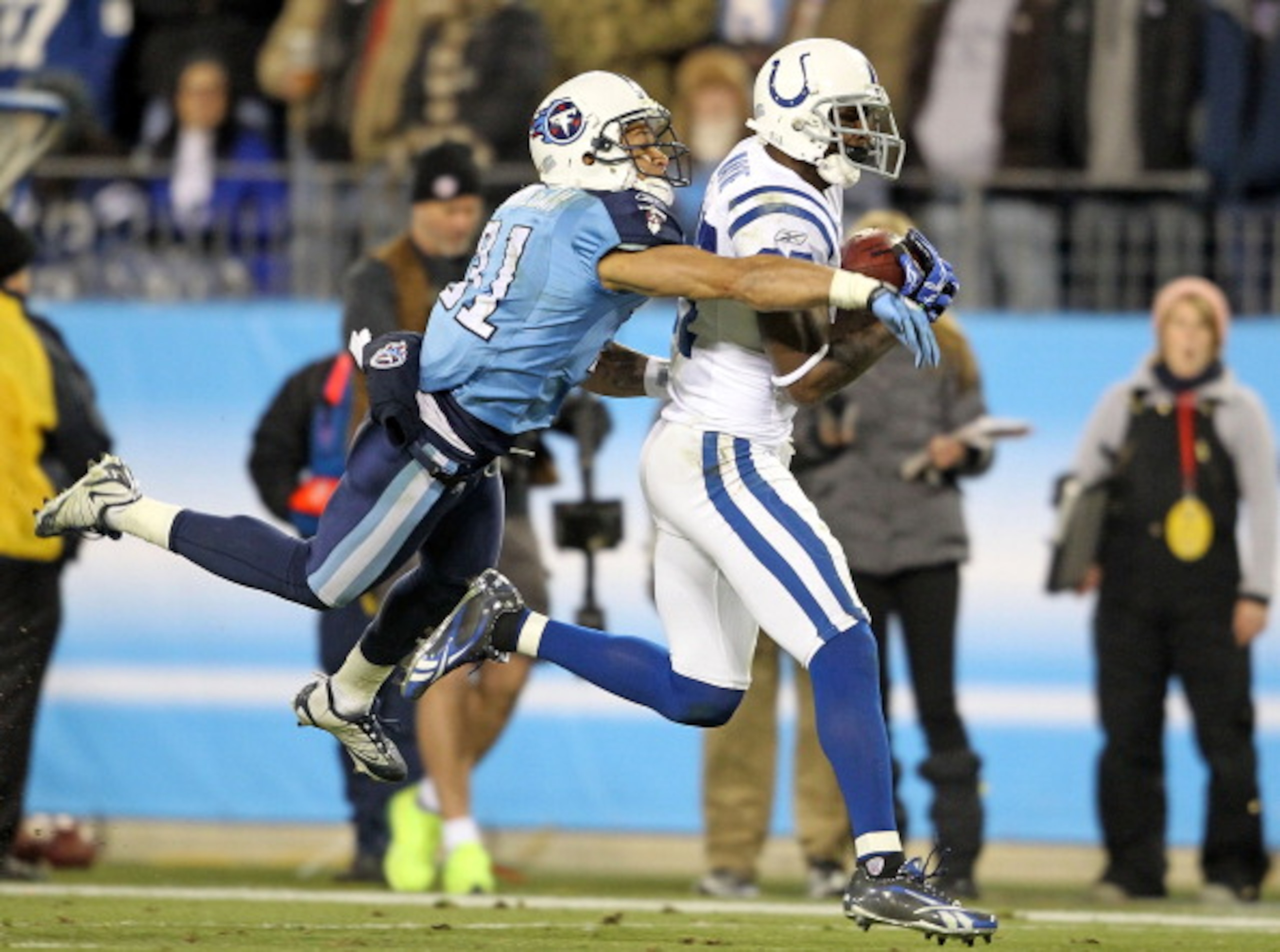 NASHVILLE, TN - DECEMBER 09:  Reggie Wayne #87 of the Indianapolis Colts catches a pass while defended by Cortland Finnegan #31  of the Tennessee Titans during the NFL game at LP Field on December 9, 2010 in Nashville, Tennessee.  (Photo by Andy Lyons/Get