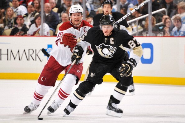 PITTSBURGH, PA - DECEMBER 20:  Sidney Crosby #87 of the Pittsburgh Penguins controls the puck in front of Shane Doan #19 of the Phoenix Coyotes on December 20, 2010 at CONSOL Energy Center in Pittsburgh, Pennsylvania.  (Photo by Jamie Sabau/Getty Images)