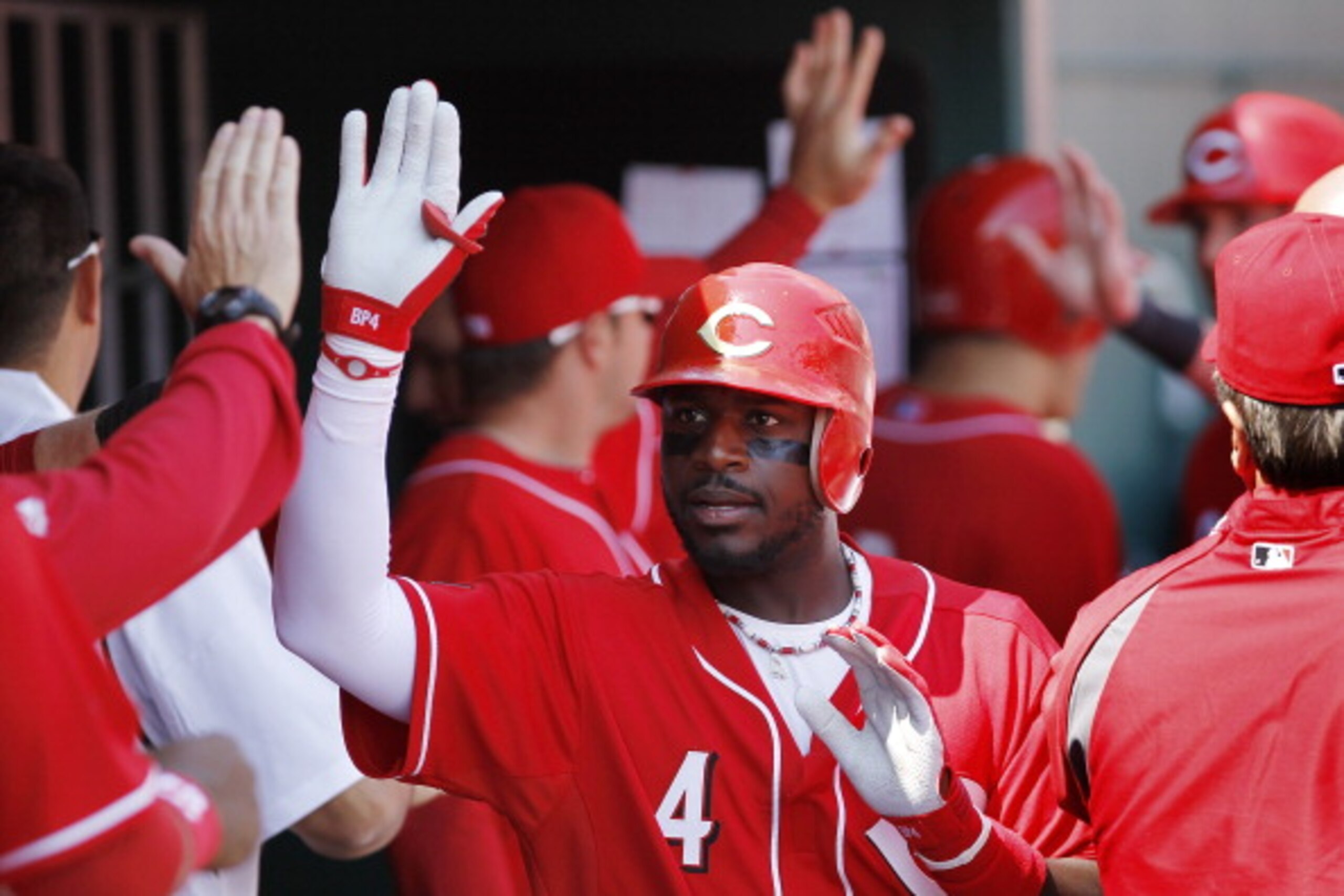CINCINNATI, OH - APRIL 3: Brandon Phillips #4 of the Cincinnati Reds celebrates with teammates after hitting a three-run home run in the 4th inning against the Milwaukee Brewers at Great American Ball Park on April 3, 2011 in Cincinnati, Ohio. The Reds wo