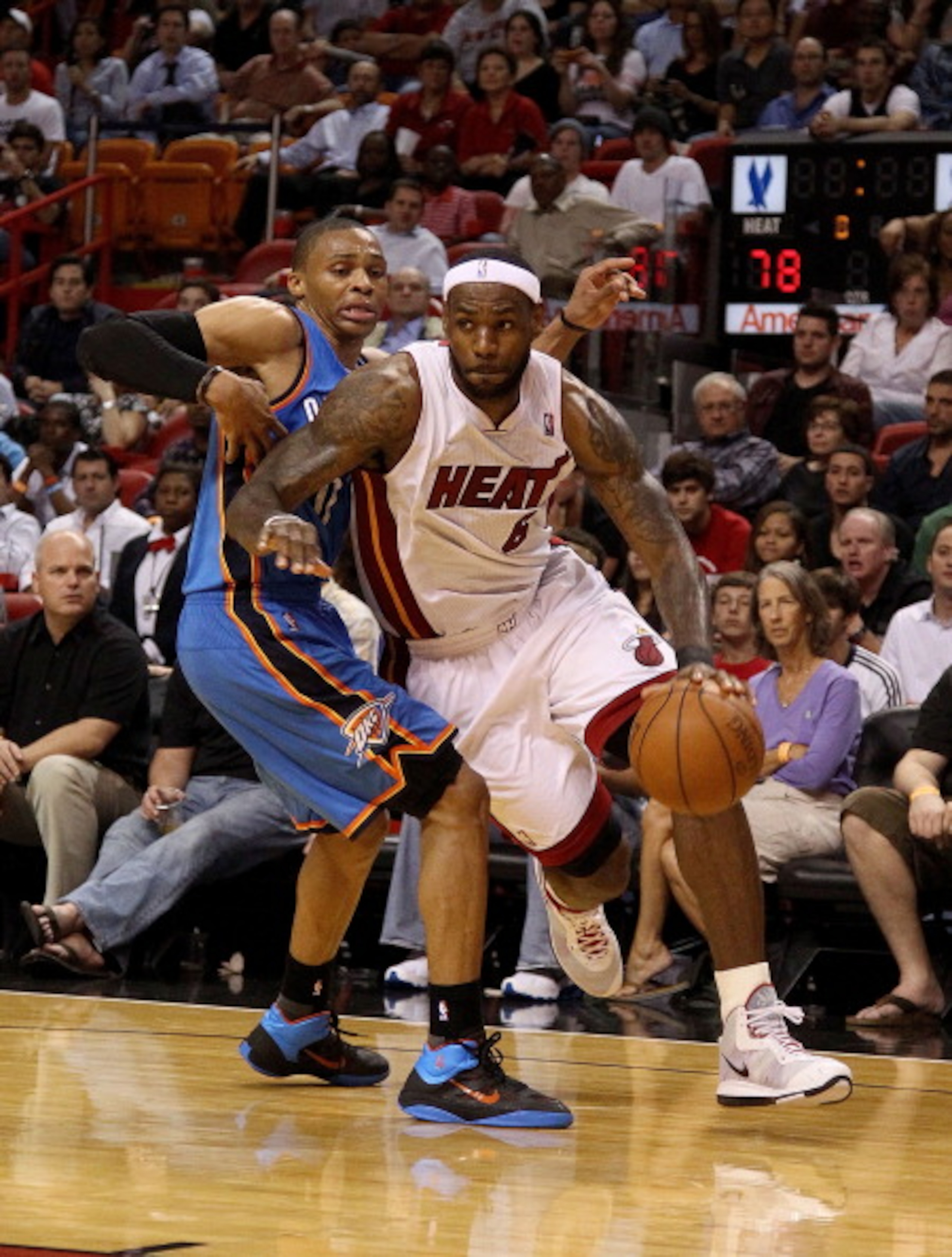 MIAMI, FL - MARCH 16:  LeBron James #6 of the Miami Heat drives by Russell Westbrook #0 of the Oklahoma City Thunder during a game at American Airlines Arena on March 16, 2011 in Miami, Florida. NOTE TO USER: User expressly acknowledges and agrees that, b