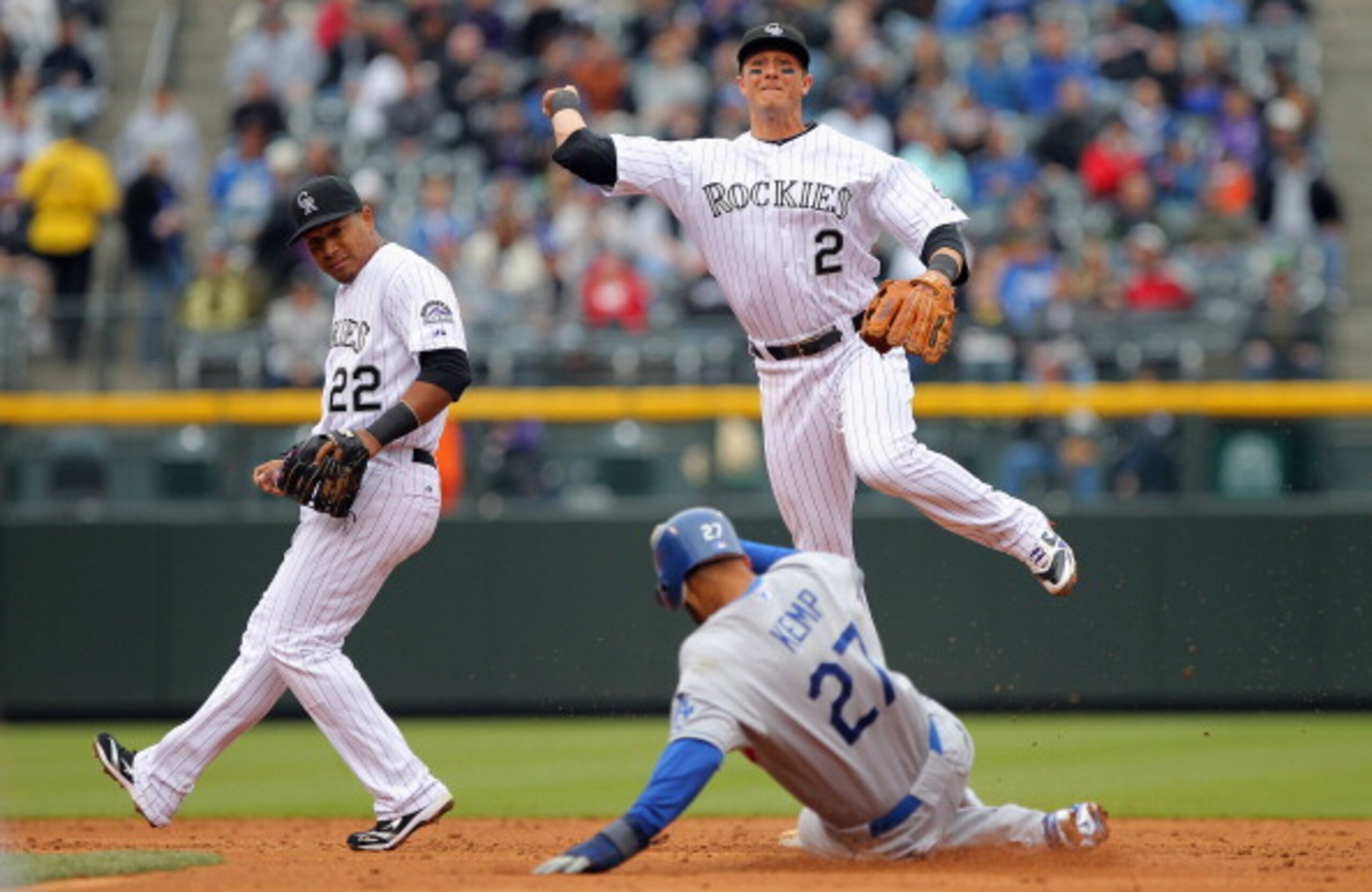 DENVER, CO - APRIL 06:  Shortstop Troy Tulowitzki #2 of the Colorado Rockies turns a double play over Matt Kemp #27 of the Los Angeles Dodgers after he fielded a ground ball by James Loney #7 of the Los Angeles Dodgers as second baseman Jose Lopez #22 of