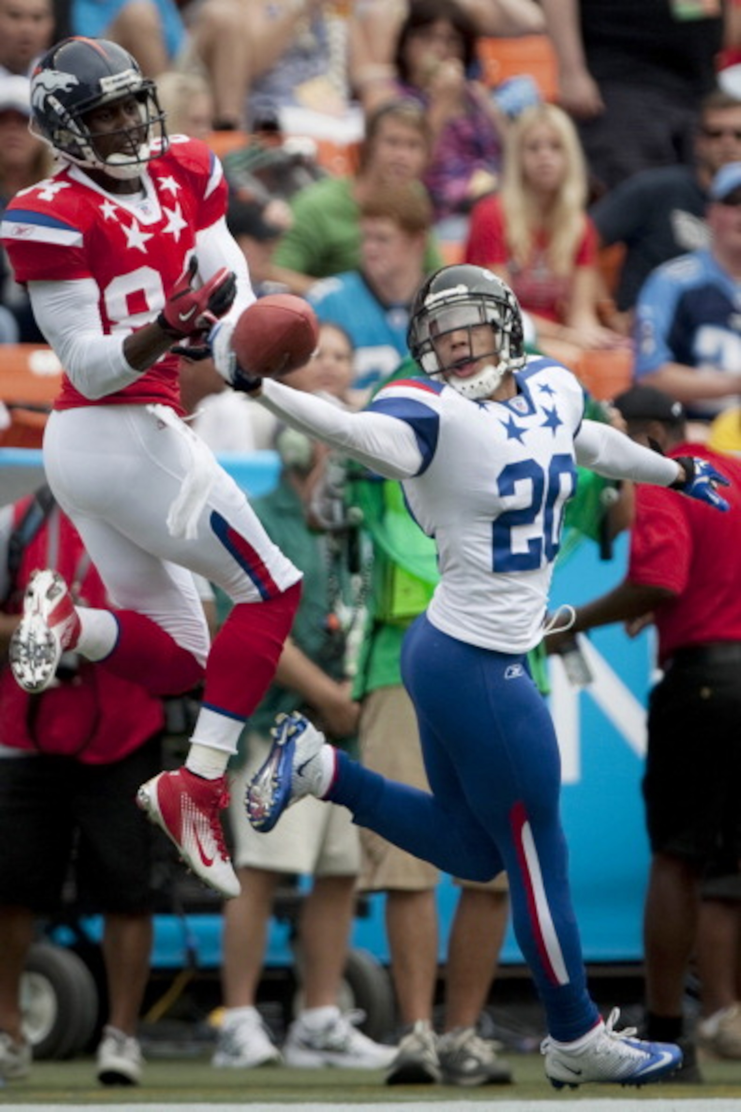 HONOLULU - JANUARY 30: Brent Grimes, #20 of the Atlanta Falcons, tries to reel in a pass intended for Brandon Lloyd, #84 of the Denver Broncos, during the 2011 NFL Pro Bowl at Aloha Stadium on January 30, 2011 in Honolulu, Hawaii. NFC won 55-41 over the HONOLULU - JANUARY 30: Brent Grimes, #20 of the Atlanta Falcons, tries to reel in a pass intended for Brandon Lloyd, #84 of the Denver Broncos, during the 2011 NFL Pro Bowl at Aloha Stadium on January 30, 2011 in Honolulu, Hawaii. NFC won 55-41 over the