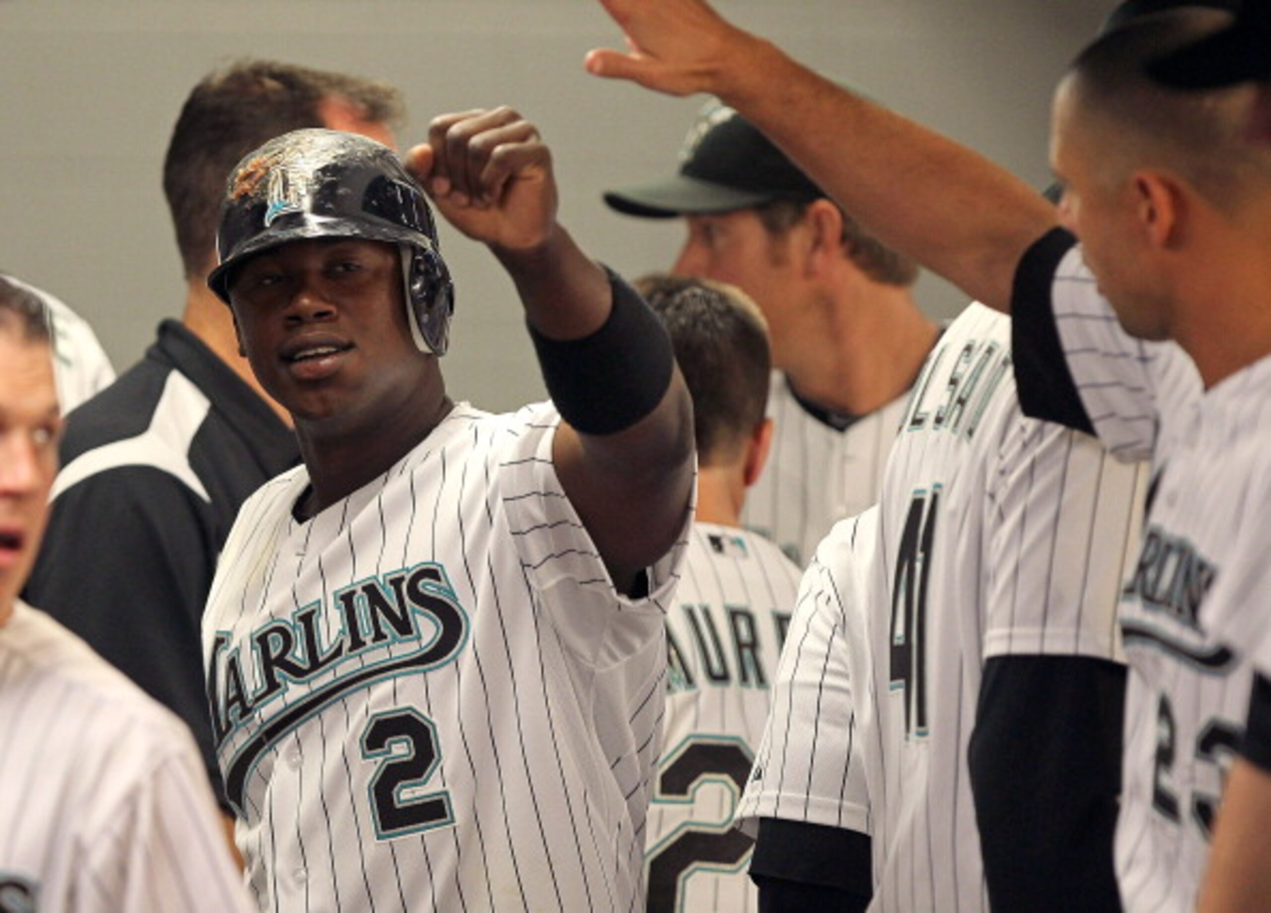 MIAMI GARDENS, FL - APRIL 01: Hanley Ramirez #2 of the Florida Marlins is congratulated after scoring a run during opening day against the New York Mets at Sun Life Stadium on April 1, 2011 in Miami Gardens, Florida.  (Photo by Mike Ehrmann/Getty Images)