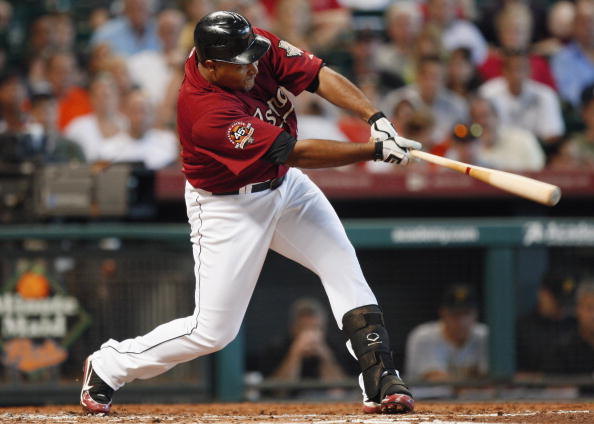 HOUSTON - AUGUST 15:  Carlos Lee #45 of the Houston Astros singles up the middle scoring Hunter Pence from second base during a baseball game against the Pittsburgh Pirates at Minute Maid Park on August 15, 2010 in Houston, Texas.  (Photo by Bob Levey/Get