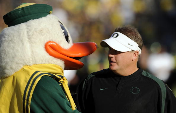 EUGENE, OR - OCTOBER 2: Head coach Chip Kelly of the Oregon Ducks is greeted by 'Puddles', the mascot of the Oregon Ducks, before the game against the Stanford Cardinal at Autzen Stadium on October 2, 2010 in Eugene, Oregon. Oregon won the game 52-31. (Ph