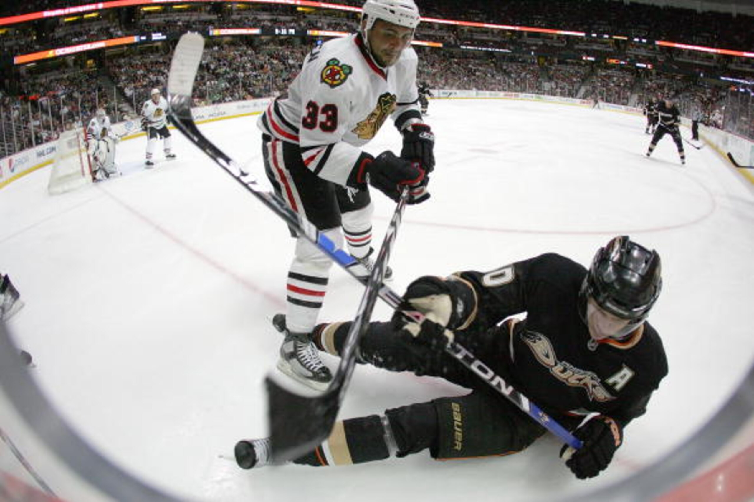 ANAHEIM, CA - MARCH 17:  Dustin Byfuglien #33 of the Chicago Blackhawks and Corey Perry #10 of the Anaheim Ducks vie for position in the corner during their NHL game at the Honda Center on March 17, 2010 in Anaheim, California. The Ducks defeated the Blac