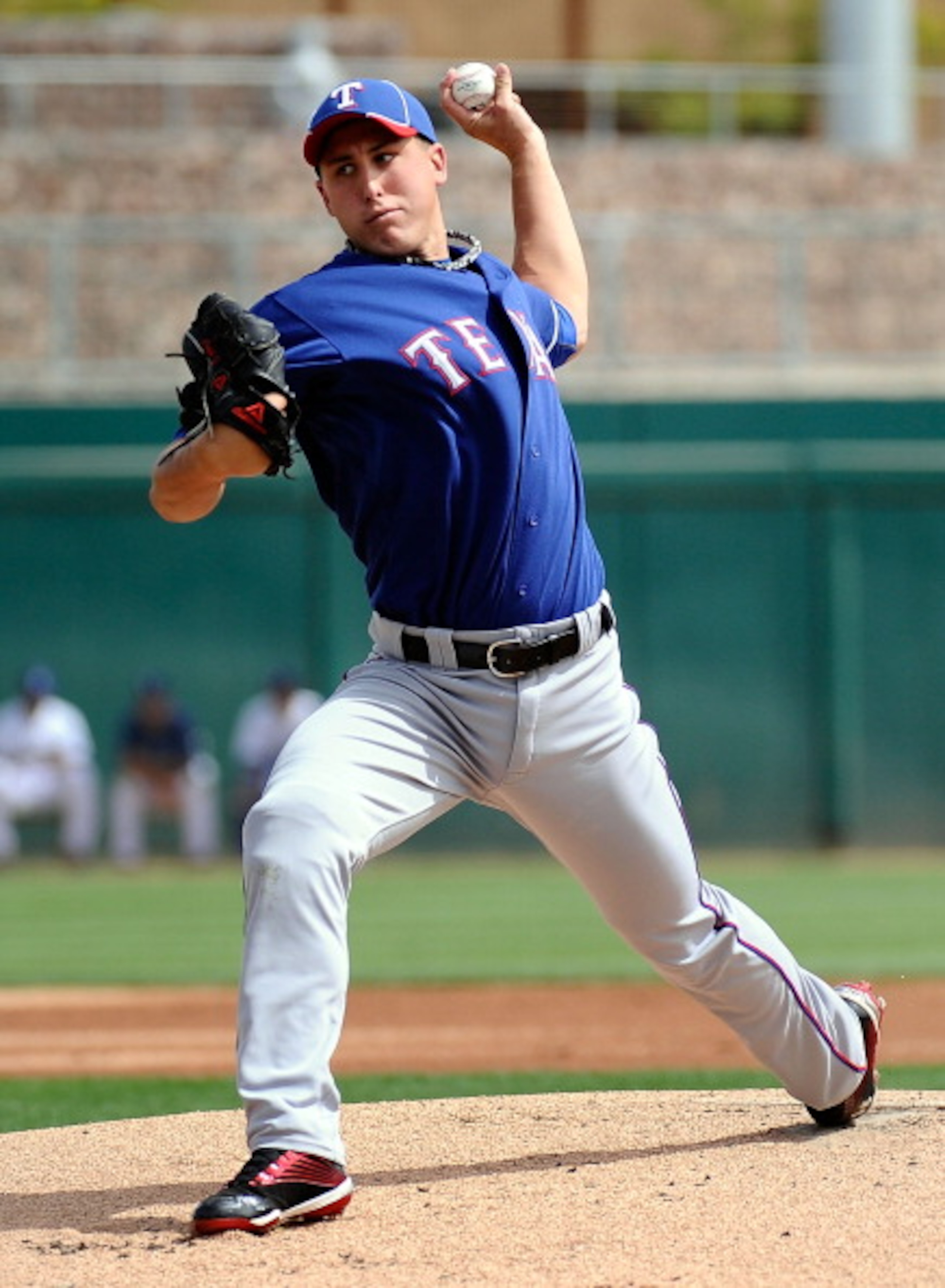 GLENDALE, AZ - MARCH 15:  Pitcher Derek Holland #45 of the Texas Rangers  throws a pitch against the Los Angeles Dodgers during the spring training baseball game at Camelback Ranch on March 15, 2011 in Glendale, Arizona.  (Photo by Kevork Djansezian/Getty