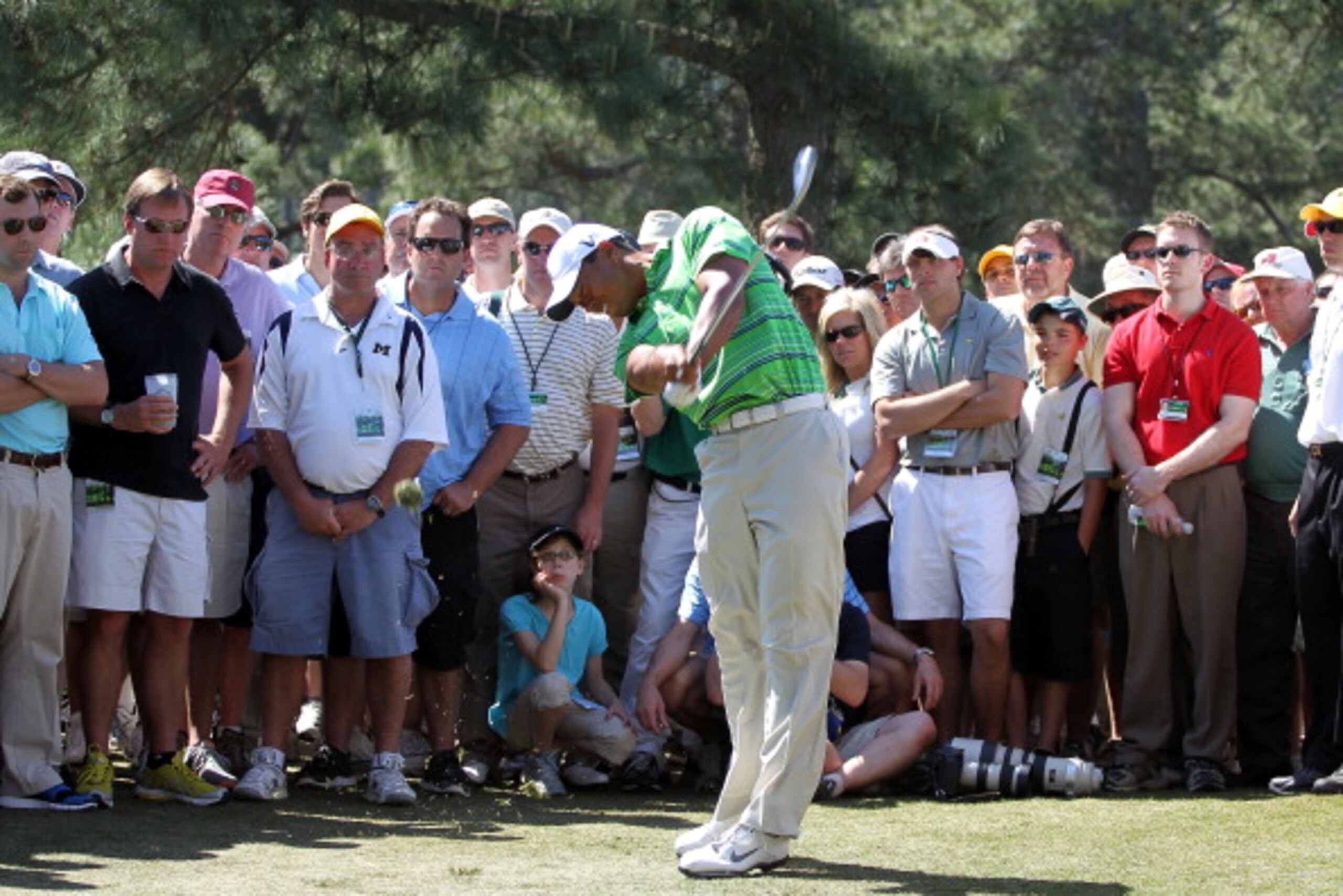 AUGUSTA, GA - APRIL 07:  Tiger Woods hits his second shot on the 17th hole in front of a gallery of patrons during the first round of the 2011 Masters Tournament at Augusta National Golf Club on April 7, 2011 in Augusta, Georgia.  (Photo by Jamie Squire/G