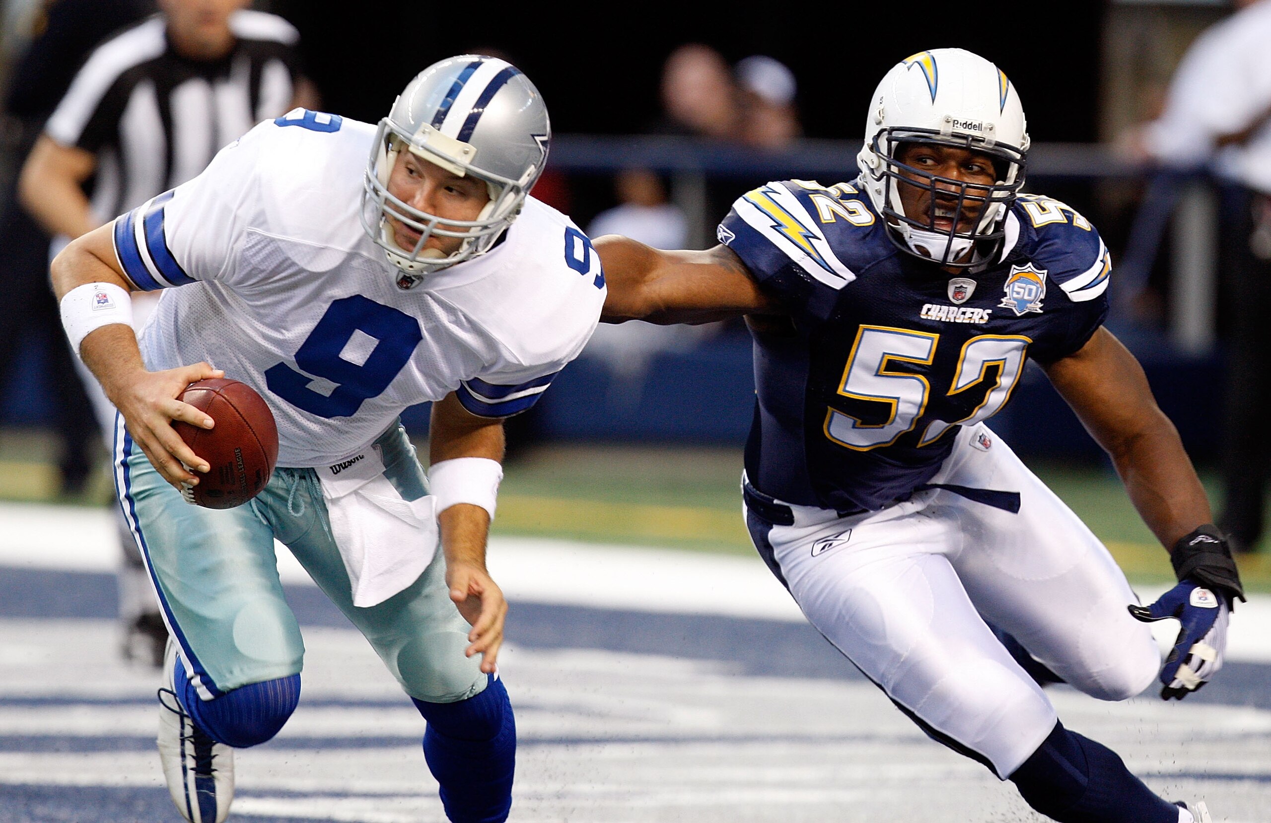 ARLINGTON, TX - DECEMBER 13:  Offensive lineman Larry English #52 of the San Diego Chargers chases Tony Romo #9 of the Dallas Cowboys at Cowboys Stadium on December 13, 2009 in Arlington, Texas.  (Photo by Ronald Martinez/Getty Images)