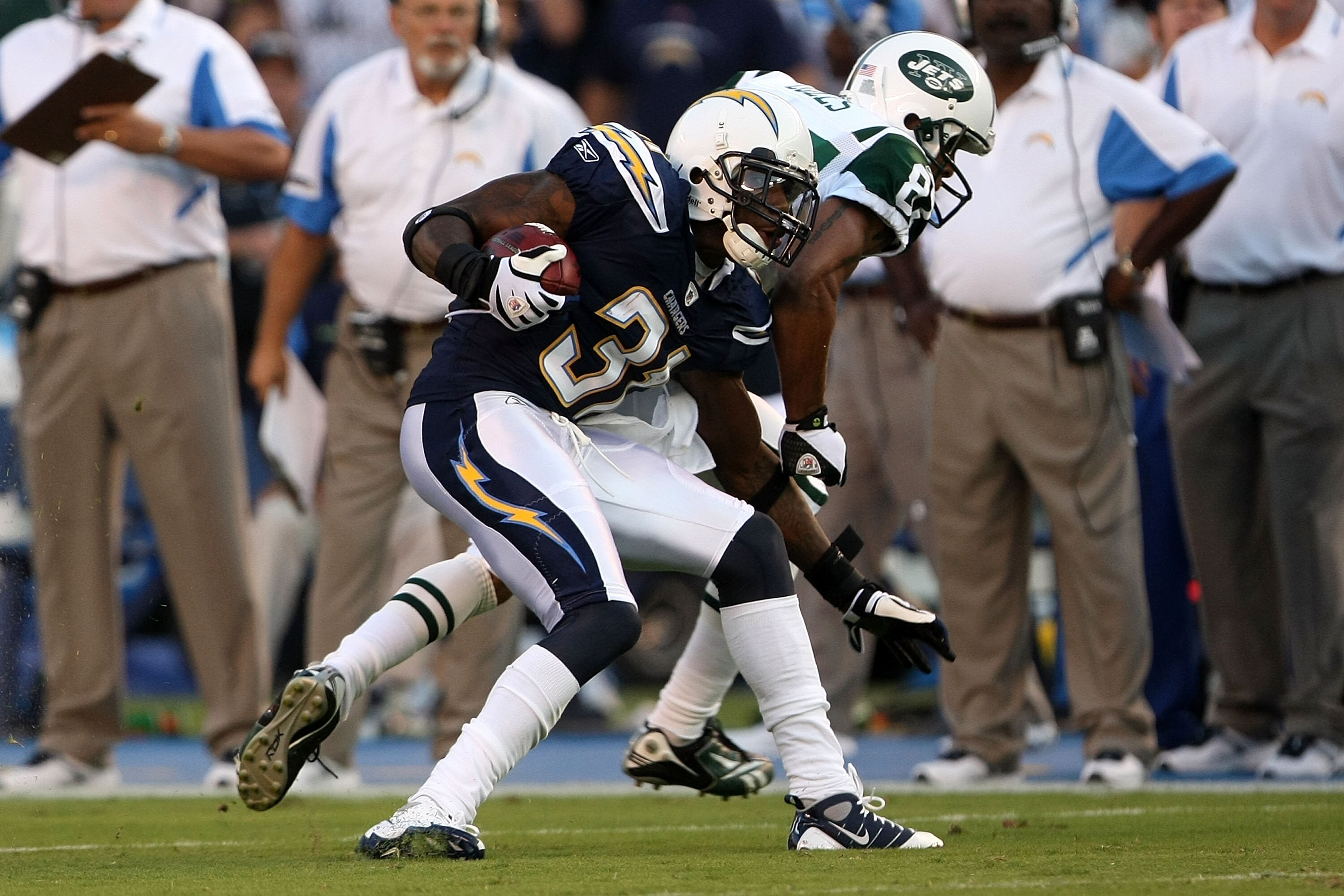 SAN DIEGO - SEPTEMBER 22:  Antonio Cromartie #31 of the San Diego Chargers catches an interception in front of wide receiver Laveranues Coles #87 of the New York Jets and returns it 52-yards for a touchdown in the second quarter while taking on the New Yo