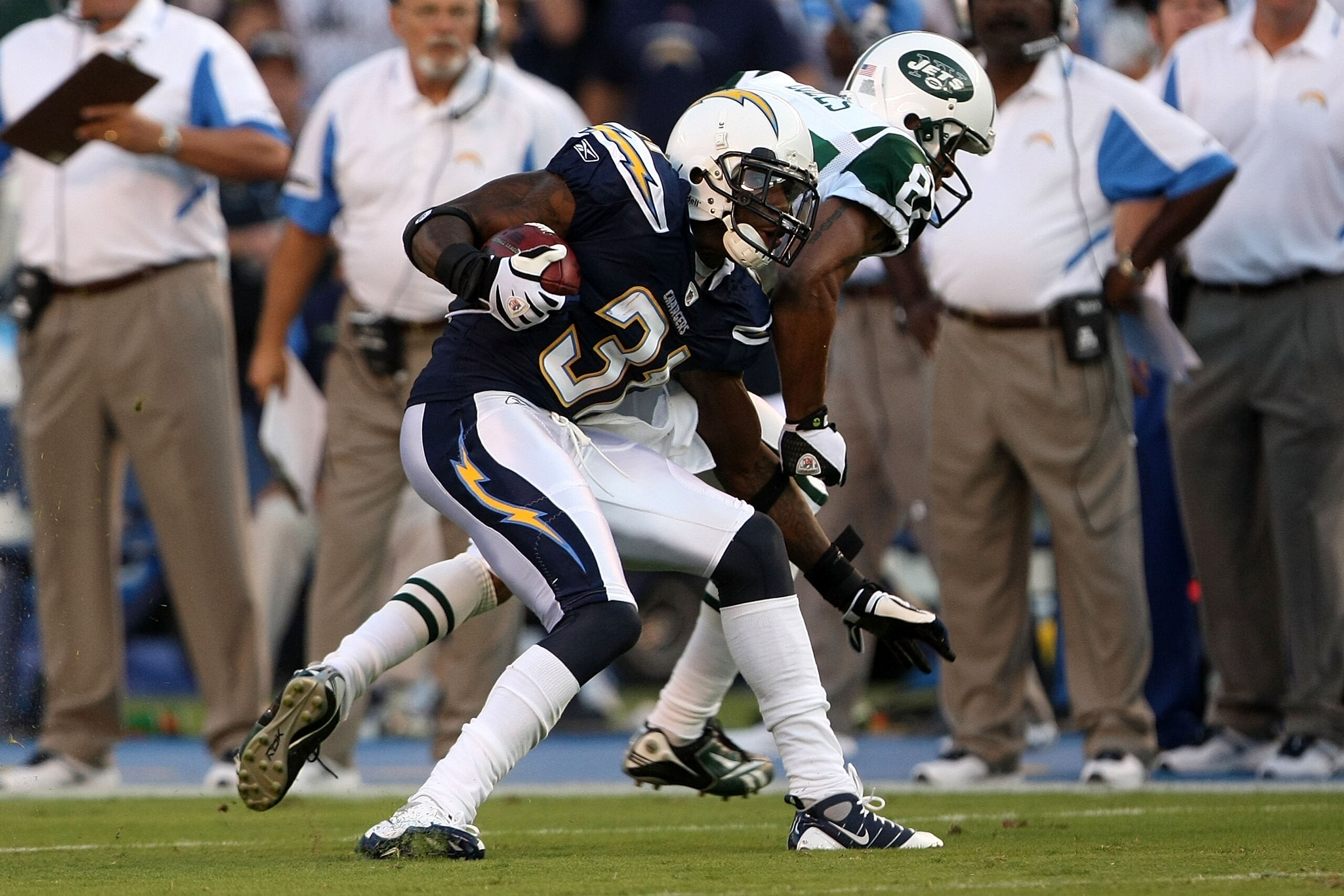 SAN DIEGO - SEPTEMBER 22:  Antonio Cromartie #31 of the San Diego Chargers catches an interception in front of wide receiver Laveranues Coles #87 of the New York Jets and returns it 52-yards for a touchdown in the second quarter while taking on the New Yo