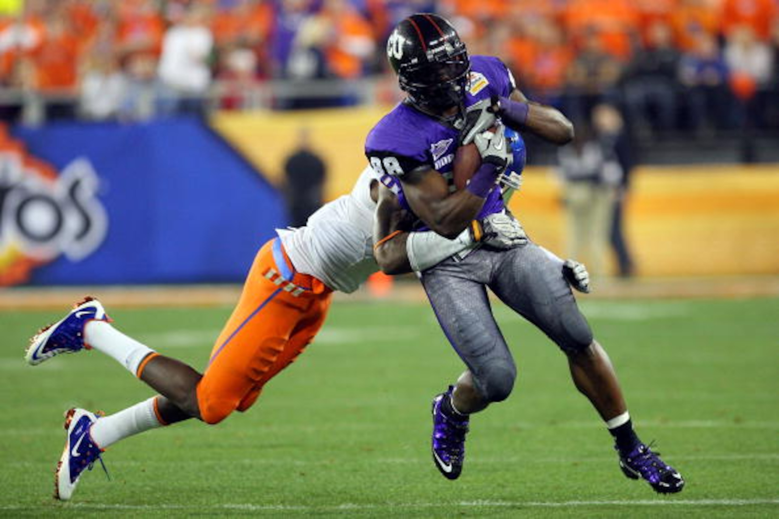 GLENDALE, AZ - JANUARY 04:  Jimmy Young #88 of the TCU Horned Frogs runs after a catch as George Iloka #8 of the Boise State Broncos attempts to tackle him in the third quarter during the Tostitos Fiesta Bowl at the Universtity of Phoenix Stadium on Janua