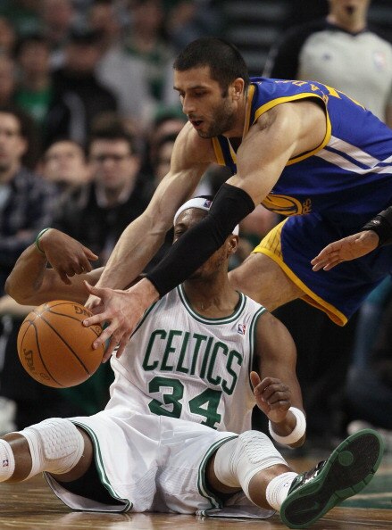 BOSTON, MA - MARCH 04:  Vladimir Radmanovic #77 of the Golden State Warriors goes after the ball as Paul Pierce #34 of the Boston Celtics tries to call a time out on March 4, 2011 at the TD Garden in Boston, Massachusetts.  The Celtics defeated the Warrio
